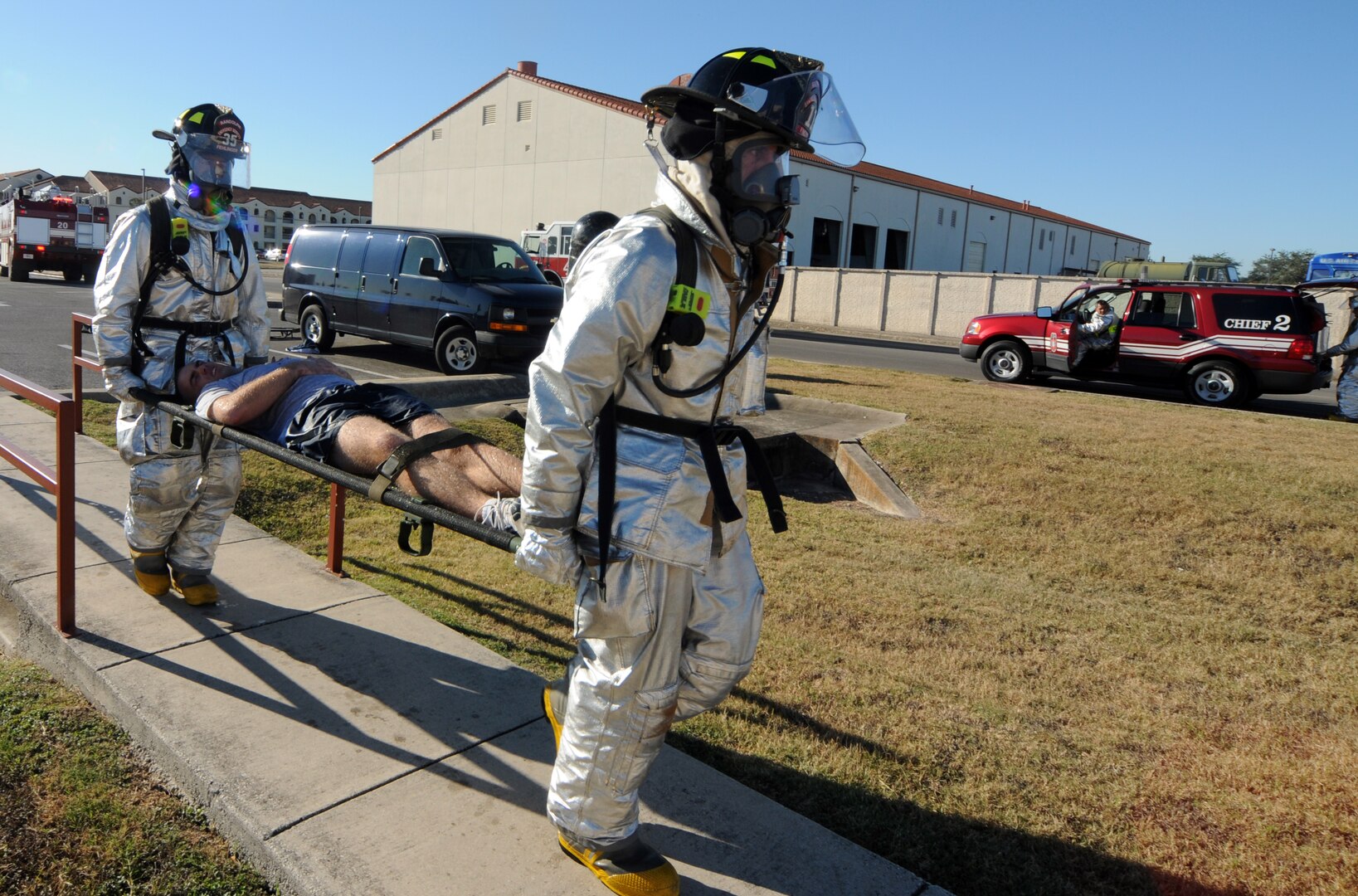 Firefighters carry a simulated victim during the exercise portion of the 2008 Operational Readiness Inspection at Randolph Air Force Base, Texas. (U.S. Air Force photo by Steve White)