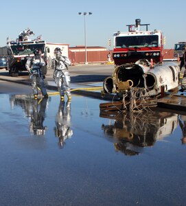 Randolph Air Force Base firefighters examine the area to ensure the "fire" from a simulated F-22 crash is fully extinguished during the exercise portion of the 2008 Operational Readiness Inspection at Randolph Air Force Base, Texas. (U.S. Air Force photo by Steve White)