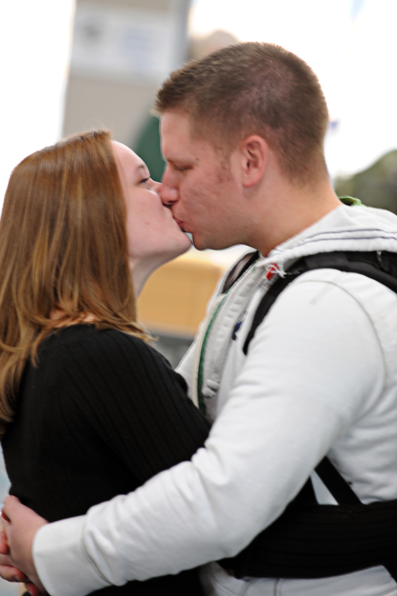 Senior Airman Shawn Mireles, 28th Security Forces Squadron leader, kisses his wife, Kelly, farewell before deploying to Southwest Asia from Rapid City Regional Airport in Rapid City, S.D., Nov. 19. While deployed, Airman Mireles will provide support to Operations Iraqi Freedom and Enduring Freedom. (US Air Force Photo/Airman 1st Class Adam Grant)