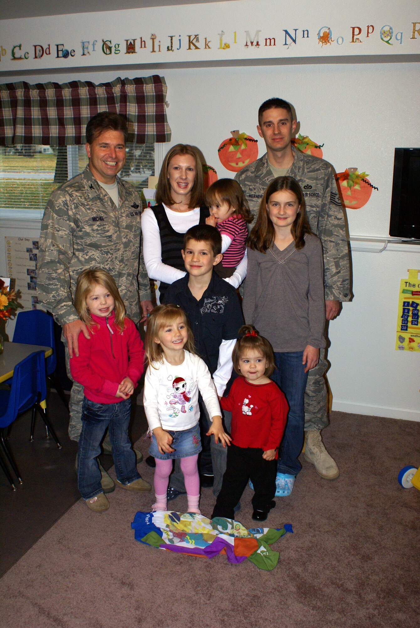 Col. John Michel, 319th Air Refueling Wing commander, presented Ms. Kristy Werner with the 2008 "Grand Forks AFB Family Child Care Provider of the Year" award here Nov. 5.   Ms. Werner has been working as a provider since August 2007. The award included a congratulatory letter, a certificate and a plaque from Benjamin D. Trotter, Chief, Services Division, Directorate of Manpower, Personnel, and Services.  Those attending the award ceremony included, Col. Joseph Douez, 319th Mission Support Group commander; Maj. Brian Lewis, 319th Force Support Squadron commander;  Chief Master Sgt. Charles Anderson, 319 MSG superintendent; Ms. Linda DePaolo, Airmen and Family Service Flight Chief, along with her family and children who participate in the Family Child Care program. (Courtesy photo)