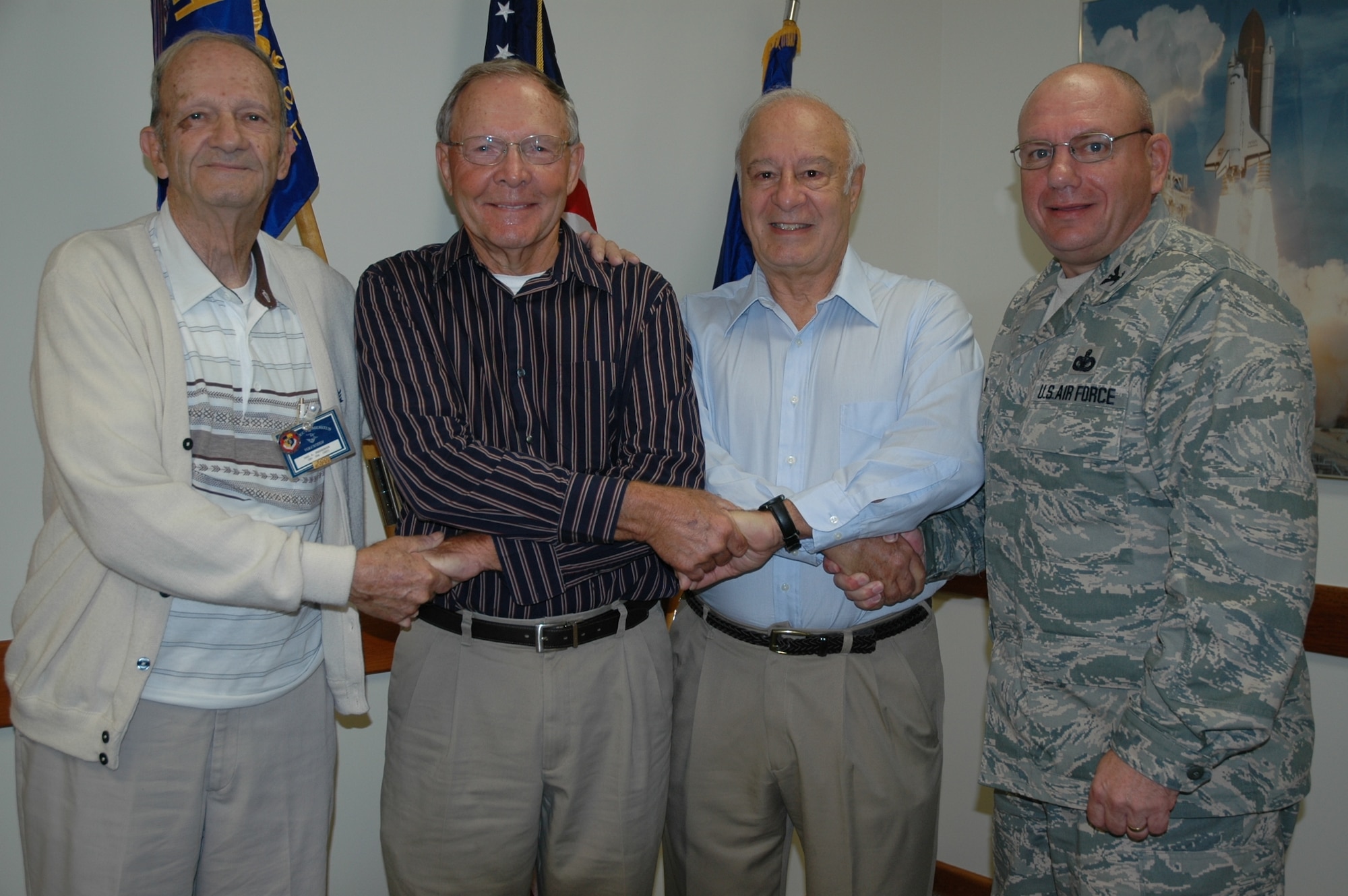 Project Emeritus volunteers (left to right) Paul Freeburger, Jerry McAnaulty, Calvin Black, and 45th Mission Support Group Commander Col. Charles Beck shake hands Tuesday in the 45th MSG Conference Room. Mr. Freeburger was coined by Colonel Beck as Project Emeritus’ Volunteer of the Quarter, while Mr. McAnaulty and Mr. Black were recognized for giving 4000 and 500 hours, respectively, of volunteer service. Not present but also recognized were Carl Guiffe, John McDunnough and Lou Mentillo, who have given 150, 1000 and 4000 volunteer hours to Project Emeritus.(U.S. Air Force photo by Airman 1st Class David Dobrydney)