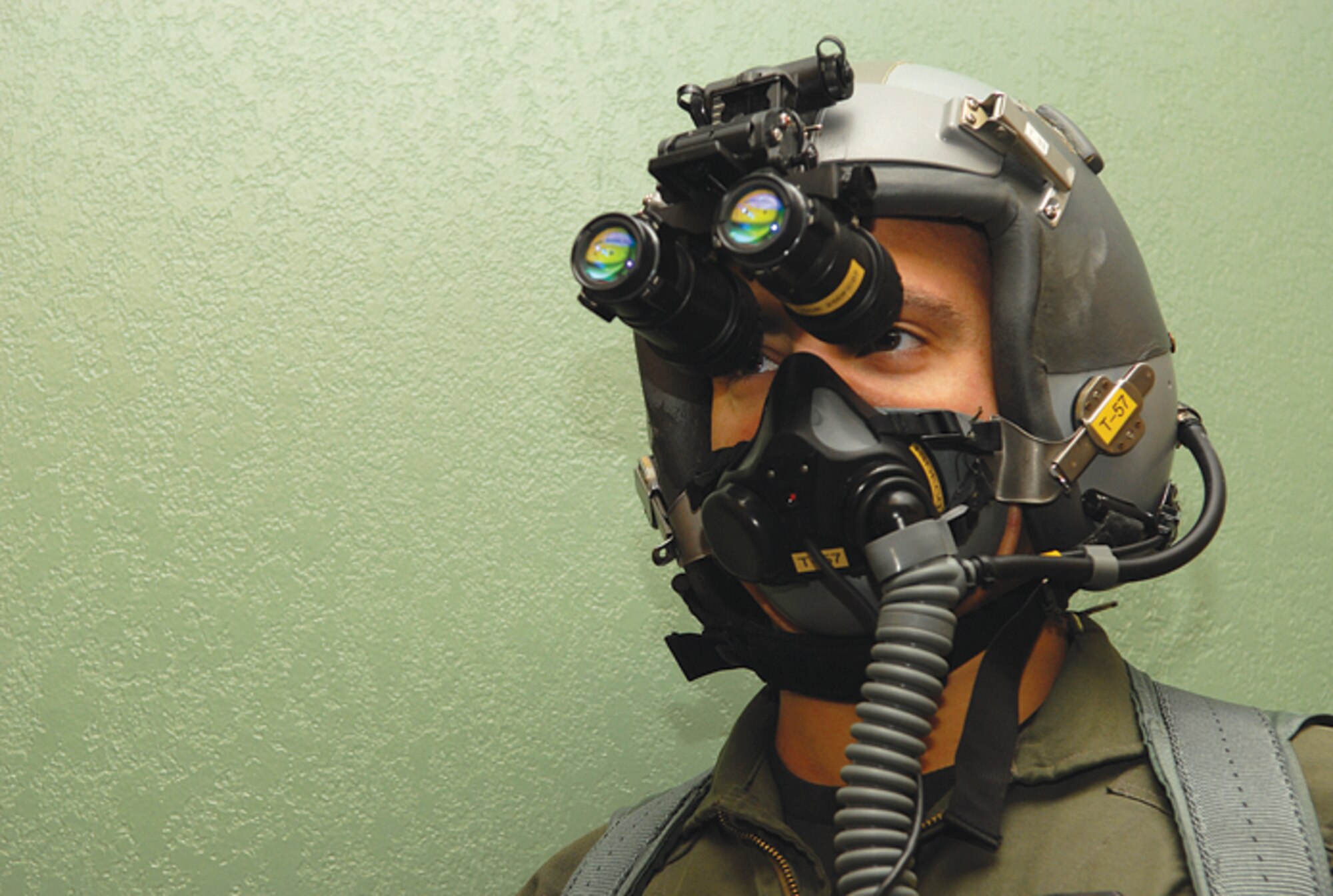 Capt. Chad Sebero, a former student pilot with the 310th Fighter Squadron, tries on night vision goggles before a flight. Instructors with the 310th FS will start teaching new students the B-course on Monday. The B-course will include night flying and training on the aircraft’s advanced systems. (U.S. Air Force photo/Staff Sgt. Ian Dean.)