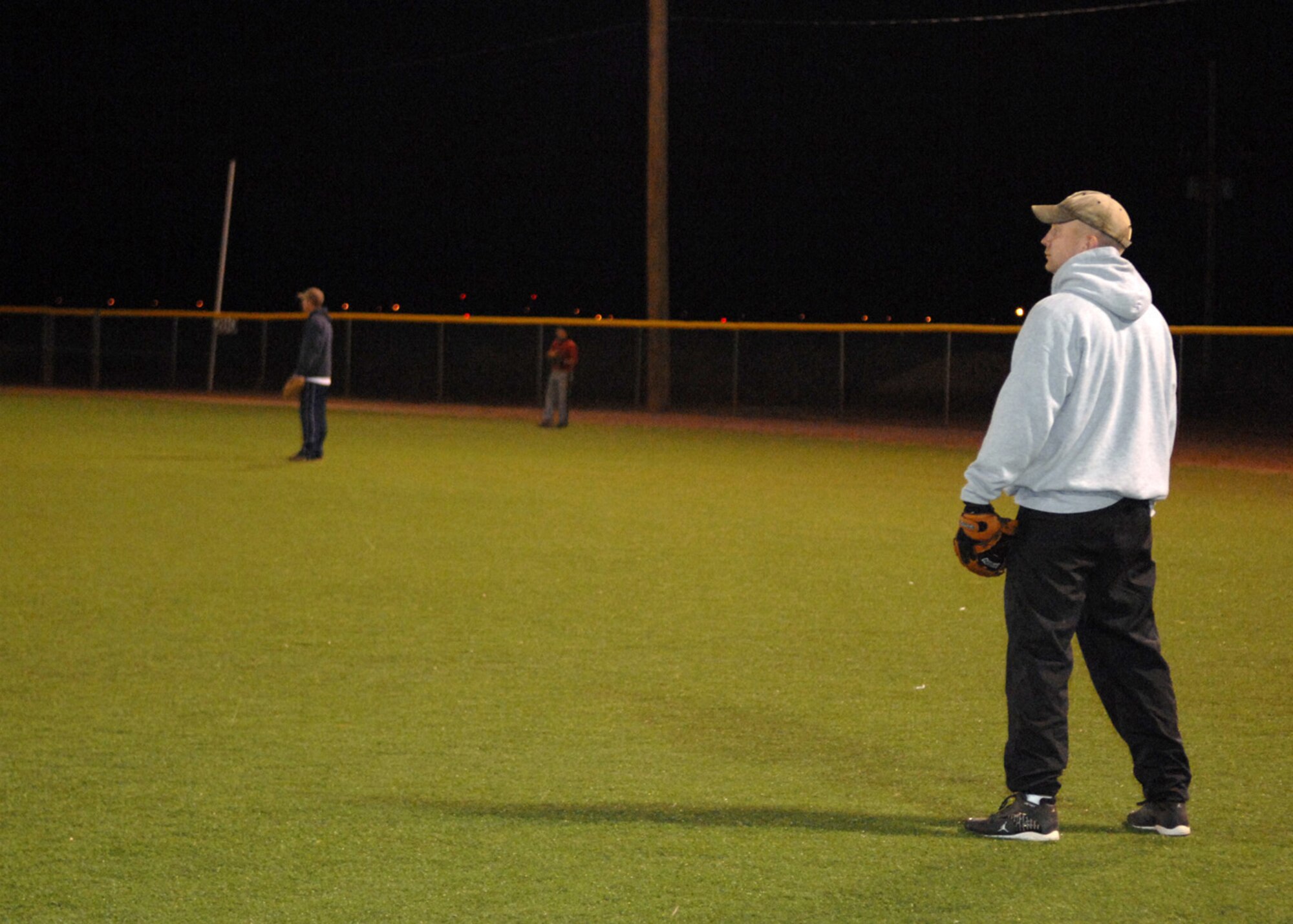 Tech. Sgt. Christopher Koscinski, 49th Security Force Squadron, stands in the outfield with other players during the varsity softball try-outs at Holloman Air Force Base, N.M., Nov. 13. Members of Holloman practiced all week for a chance to be a part of the base varsity softball team. (U.S. Air Force photo/Airman 1st Class Veronica Salgado)