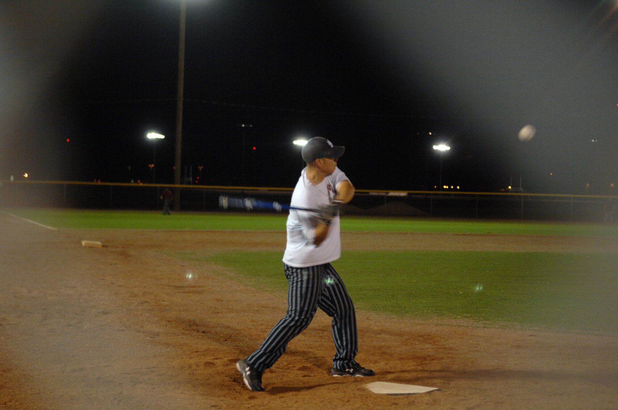 Tech. Sgt. William Velaz, 49th Security Force Squadron, swings his bat during the varsity softball try-outs at Holloman Air Force Base, N.M., Nov. 13. Players that were interested in joining the base varsity softball team met up at the baseball field to practice. (U.S. Air Force photo/Airman 1st Class Veronica Salgado)