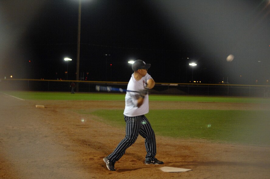 Tech. Sgt. William Velaz, 49th Security Force Squadron, swings his bat during the varsity softball try-outs at Holloman Air Force Base, N.M., Nov. 13. Players that were interested in joining the base varsity softball team met up at the baseball field to practice. (U.S. Air Force photo/Airman 1st Class Veronica Salgado)