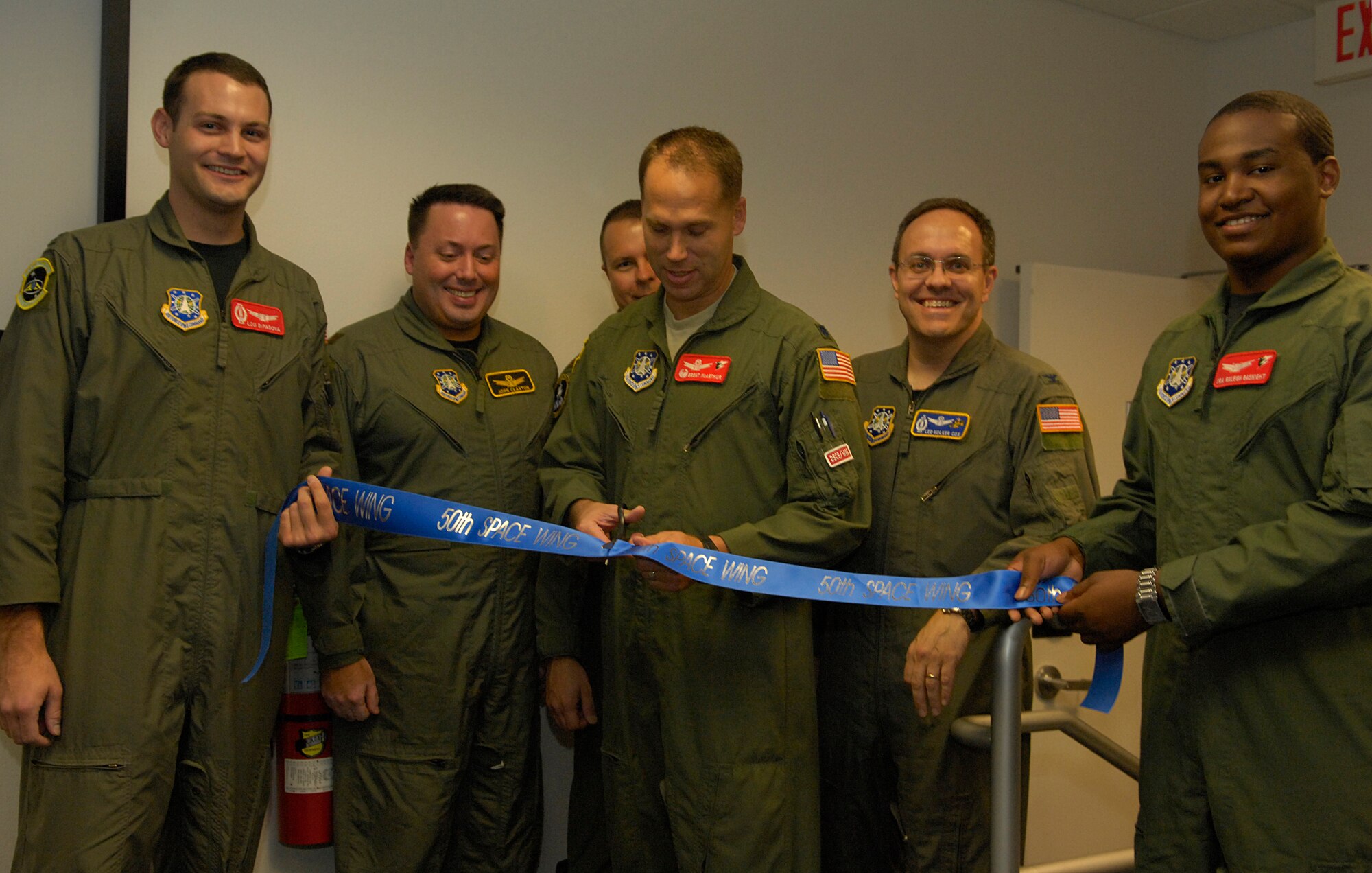 VANDENBERG AIR FORCE BASE, Calif-  Lt. Col. Brent McArthur, commander of the 3rd Space Operations Squadron, cuts a ribbon to announce the opening of 3rd SOPS, at the Vandenberg tracking station Nov. 12.  The 3rd SOPS operates under the 50th Space Wing located at Schriever AFB, Colo. (U.S. Air Force Photo/Airman 1st Class Andrew Lee)