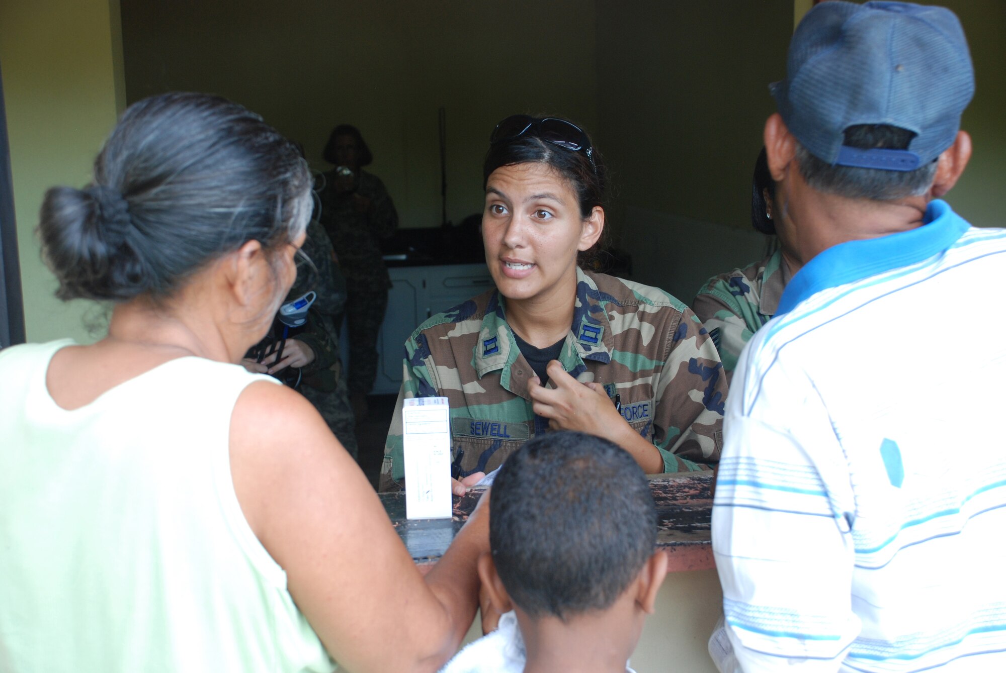Capt. Elizabeth Sewell, a pharmacist from JTF-Bravo's Medical Element, explains a medication to a patient Nov. 13 in Burrell Boom, Belize. More than 600 people were seen by U.S. and Belize military medical personnel in two different villages ravaged by flood water.