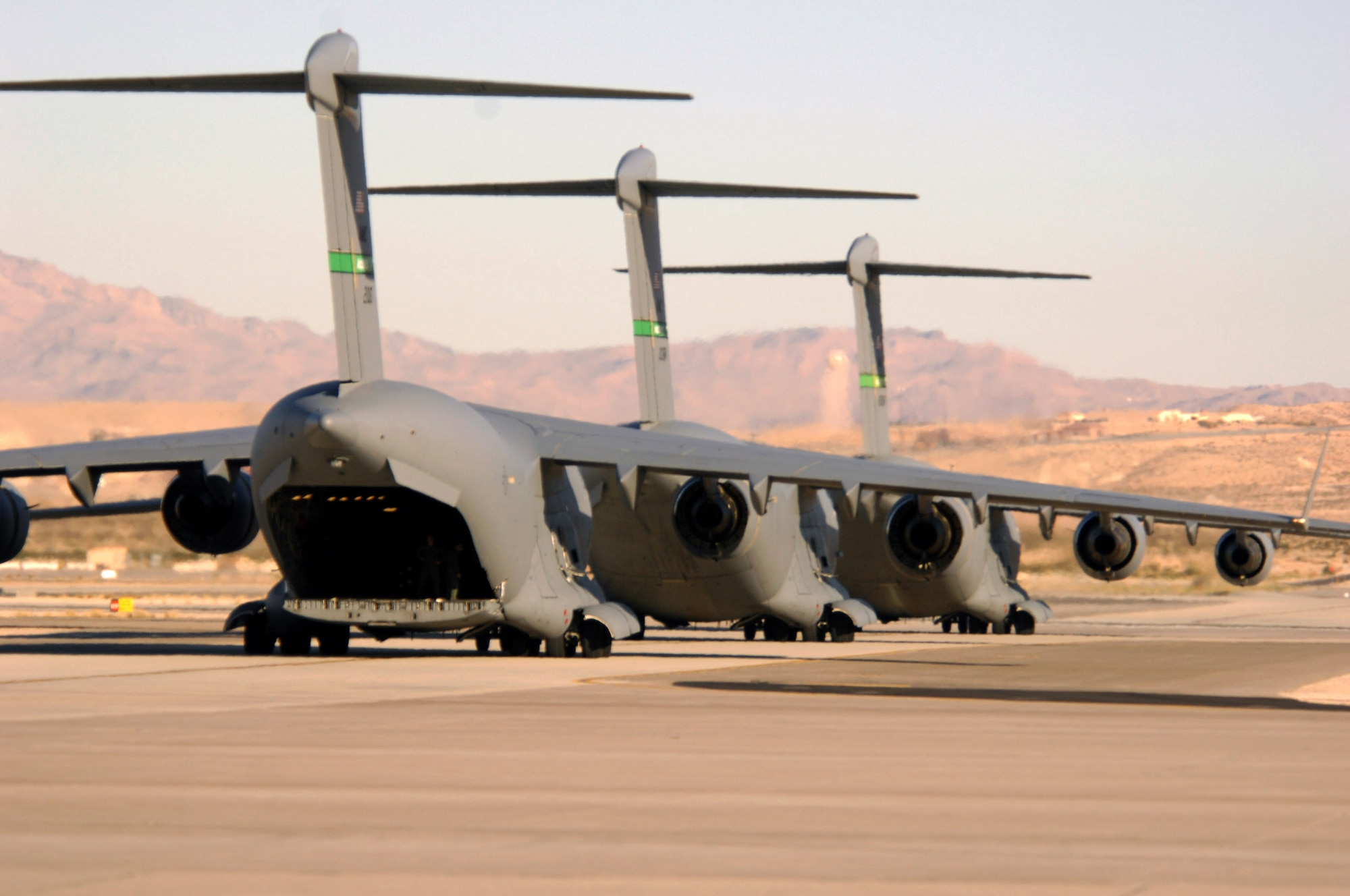 C-17 Globemasters taxi during the Mobility Air Forces Exercise, MAFEX, Nov. 19, 2008, Nellis Air Force Base, Nev. Approximately twelve U.S. Air Force bases participate in MAFEX at the U.S. Air Force Weapons School twice a year, testing C-17 Globemasters and C-130 Hercules crews' ability to join together in formation at a specific time and location to drop a brigade-size force anywhere in the world.  (U.S. Air Force photo / Senior Airman Jason R. Huddleston)

