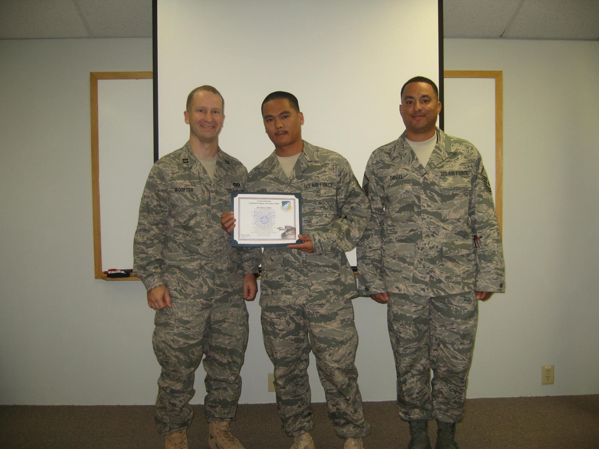 SEYMOUR JOHNSON AIR FORCE BASE, N.C. -- Tech. Sgt. Alexander Tadeo (center), a pest managementtechnician with the 916th Civil Engineer Squadron, receives his promotion certificate from Capt. ChrisWoofter (left), squadron commander and Master Sgt. Dover Daniel, supervisor.
