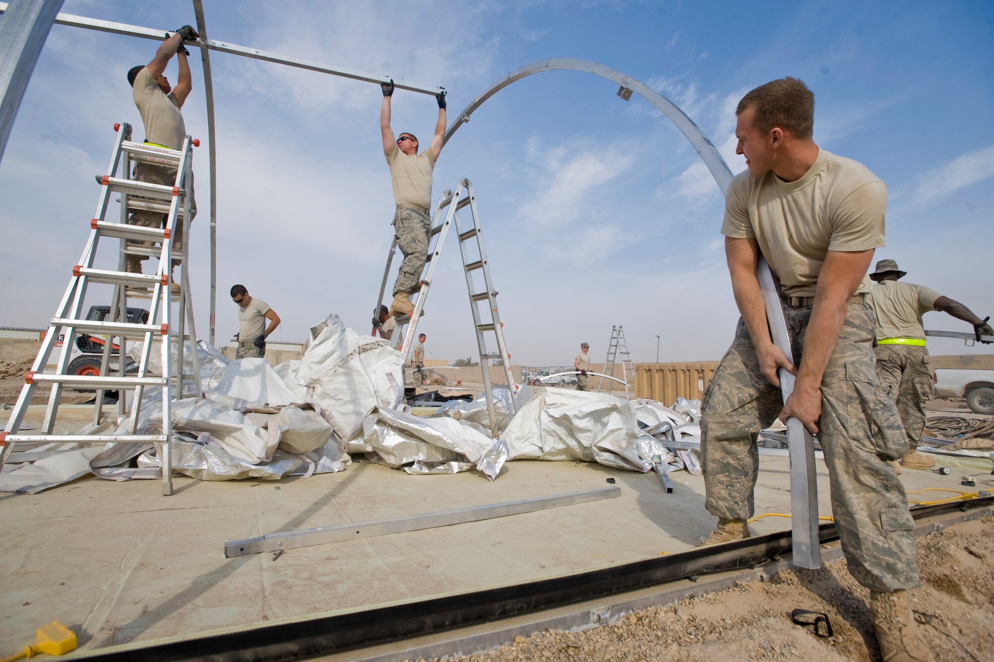 ALI BASE, Iraq -- Airmen from the 407th Expeditionary Civil Engineer Squadron pull up Alaskan shelter support beams Nov. 19, 2008. The 407th ECES Airmen improve living conditions by tearing down Alaskan shelters to make room for trailers which they will move into once completed. (U.S. Air Force photo/Senior Airman Christopher Griffin)