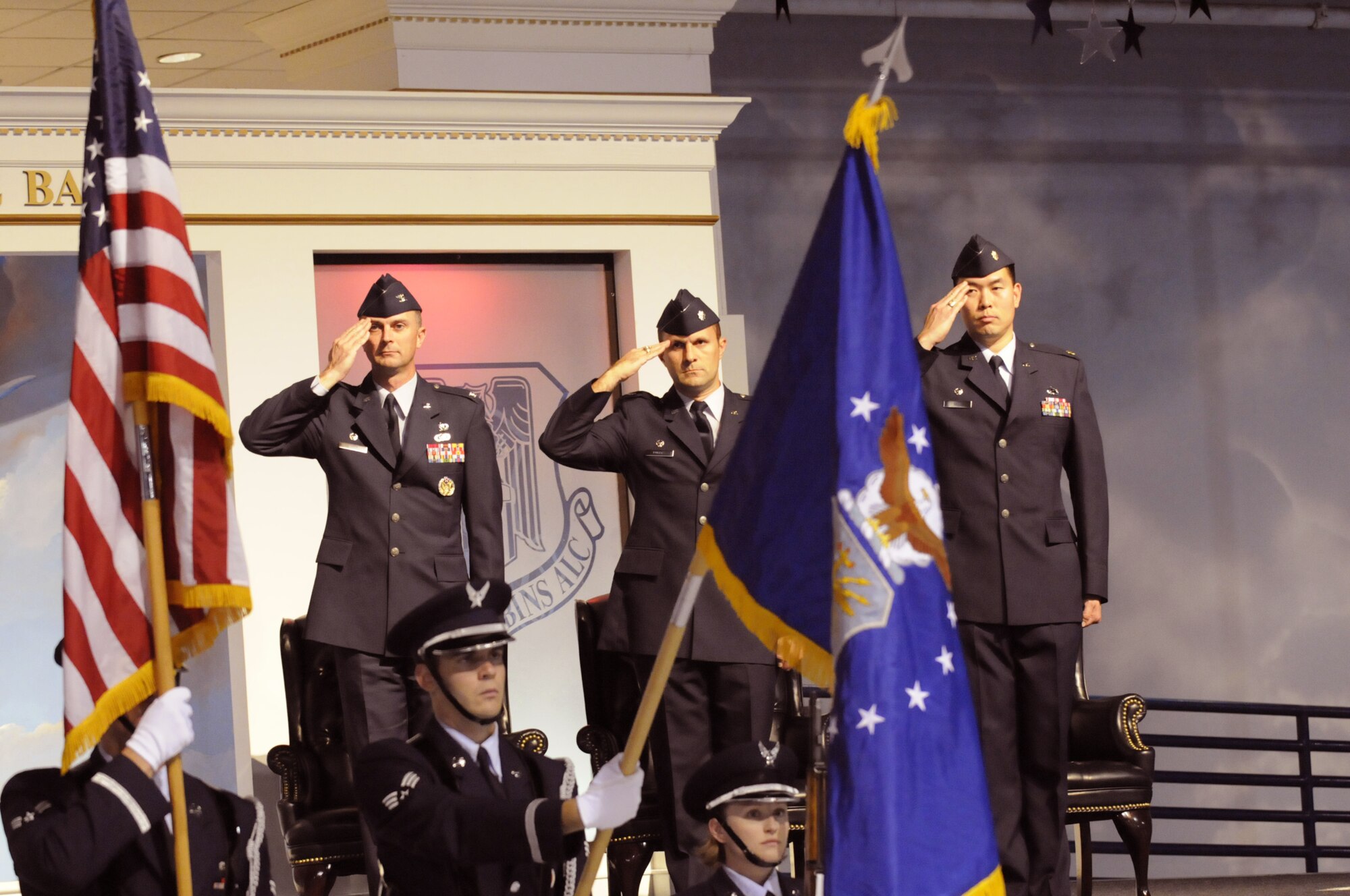 Col. Warren Berry, Lt. Col. Christopher Rogers and Major Al Seto salute during the national anthem at the activation ceremony for the 78th Comptroller and Contracting Squadron at the Museum of Aviation Nov. 13. U. S. Air Force photo by Sue Sapp