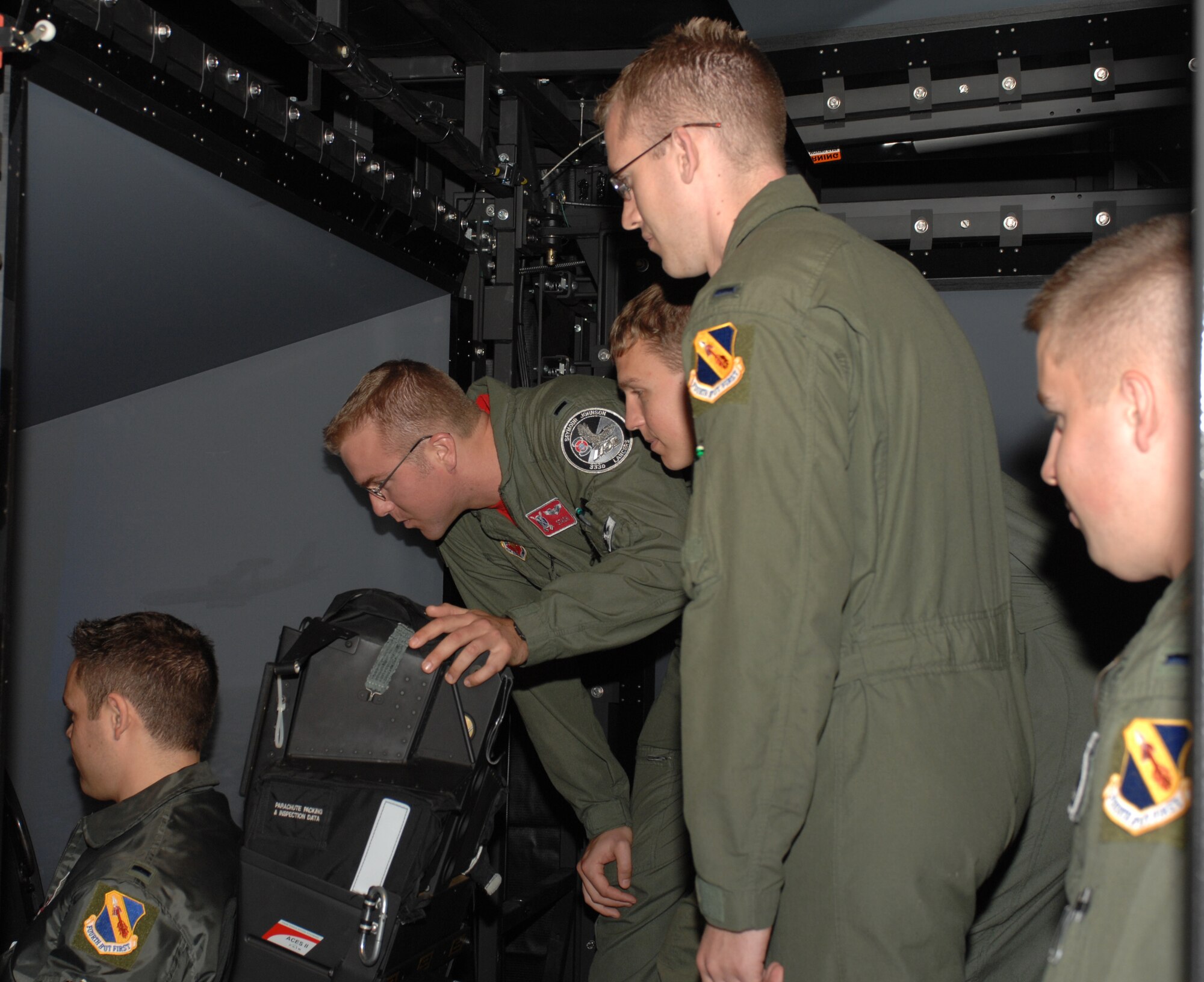 Fourth Fighter Wing Airmen observe the displays at a mission training center Nov. 14 on Seymour Johnson Air Force Base, N.C. With rising fuel costs, the MTC's will begin to play a larger role in training.(U.S. Air Force photo by Airman 1st Class Gino Reyes)