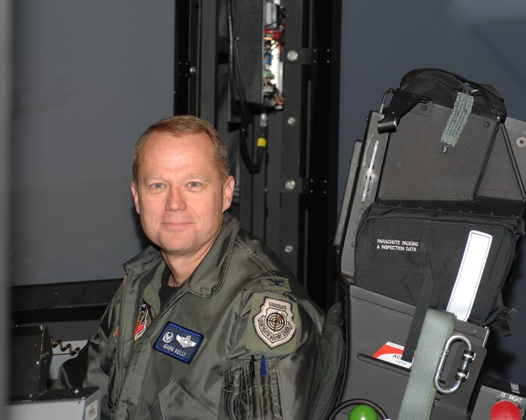 Base commander Col. Mark D. Kelly sits in a mission training center Nov. 14 at Seymour Johnson Air Force Base, N.C. A mission training center is a flight simulator where aircrews can practice real-life scenarios without the cost of fuel or the potential of danger. (U.S. Air Force photo by Airman 1st Class Gino Reyes)