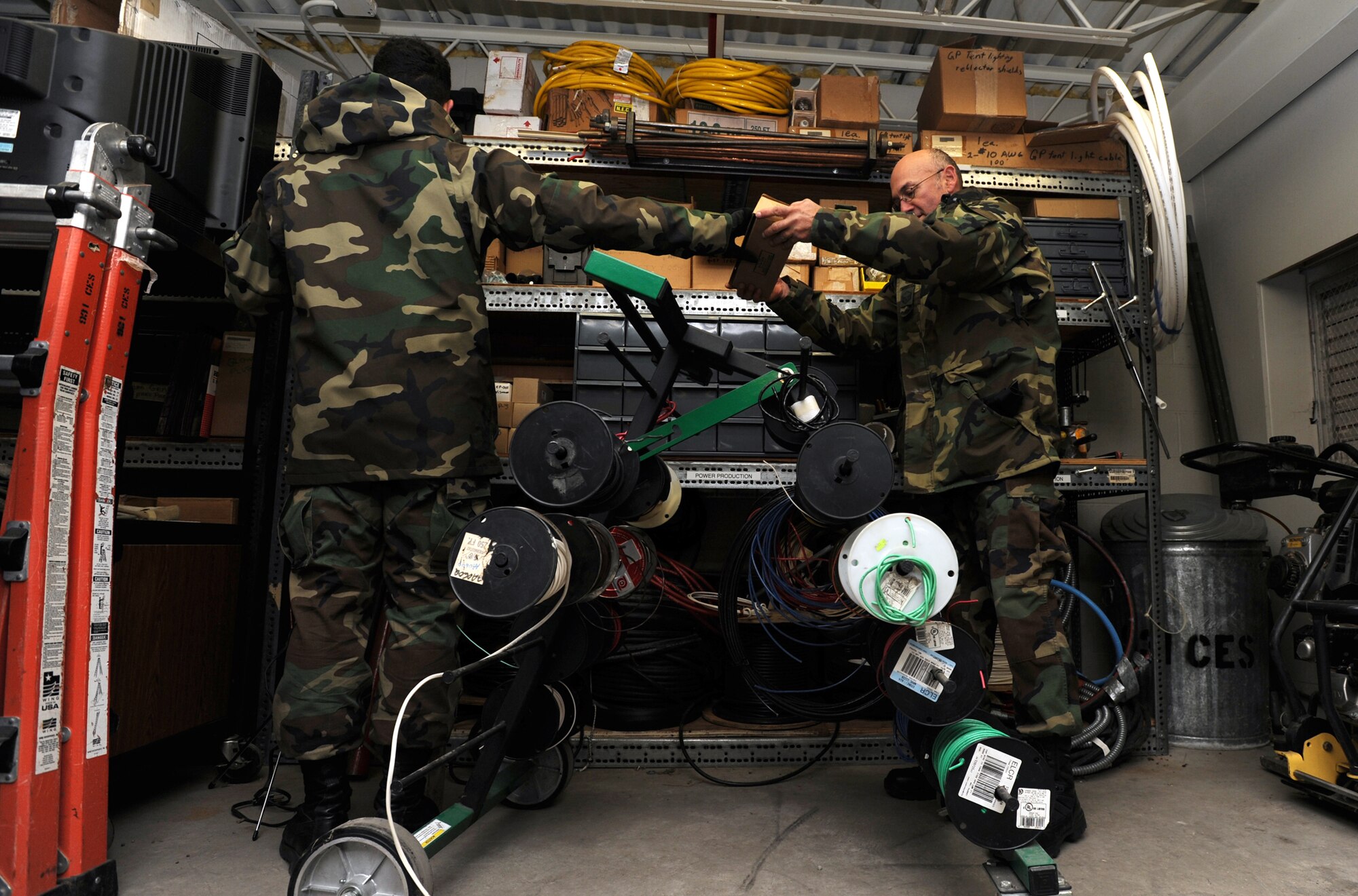 Master Sgt. Ed Craig (right) and Senior Airman Jason Garcia look for battery terminals inside a 931st Civil Engineer Squadron storage area during the November Unit Training Assembly. Both Airmen are Reservists assigned to the CES shop that maintains generators and other equipment used for providing electrical power in deployed and other field conditions. Their squadron is part of the 931st Air Refueling Group, an Air Force Reserve unit at McConnell Air Force Base, Kan. (U.S. Air Force photo/Tech. Sgt. Jason Schaap)