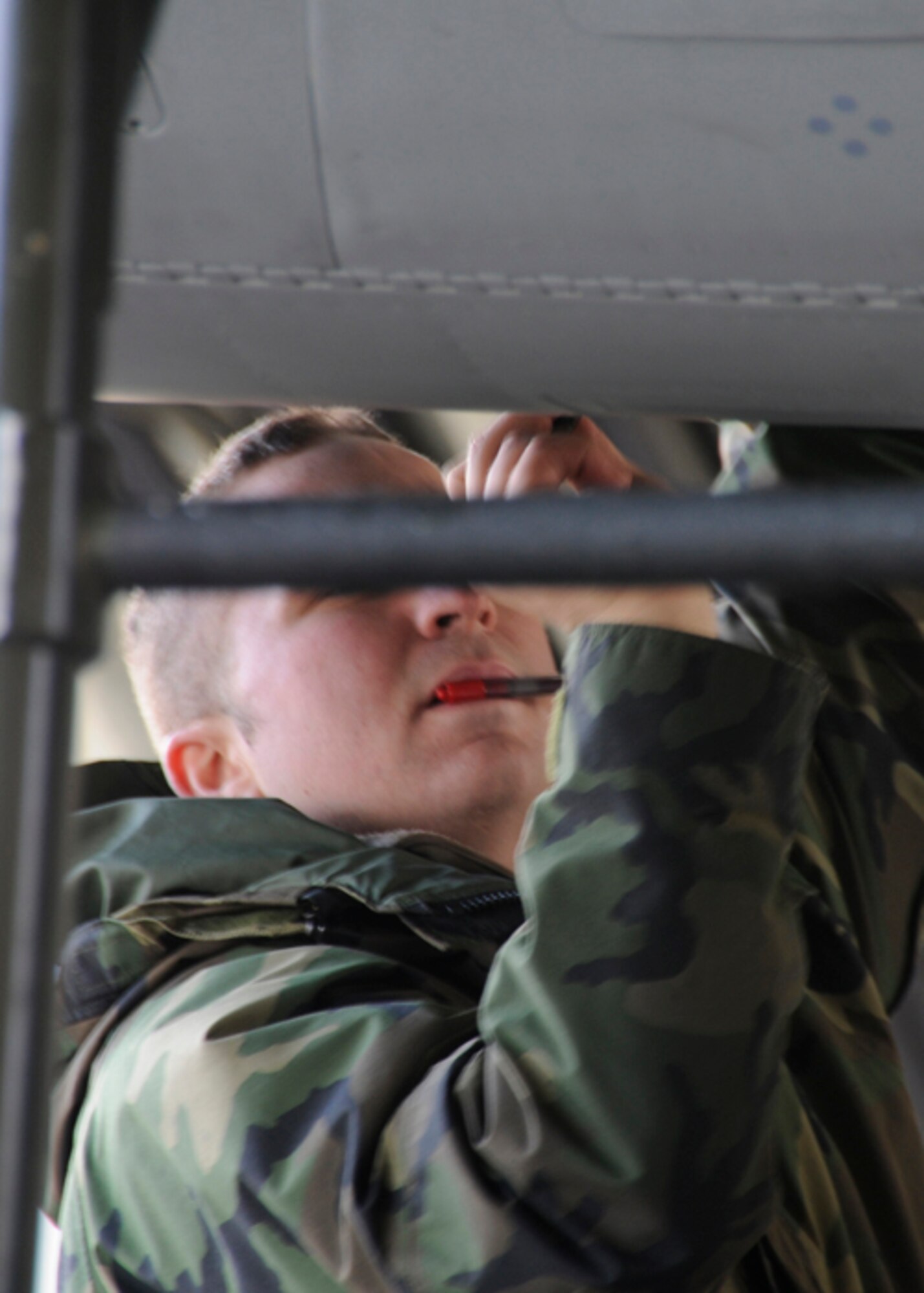 Senior Airman Joseph Mann, 493rd Expeditionary Fighter Squadron crew chief, performs necessary inspections post-flight to ensure the aircraft maintains its alert status Nov. 11 at Siauliai, Lithuania. The F-15’s are required to be airborne within 15 minutes of an alert signal. 