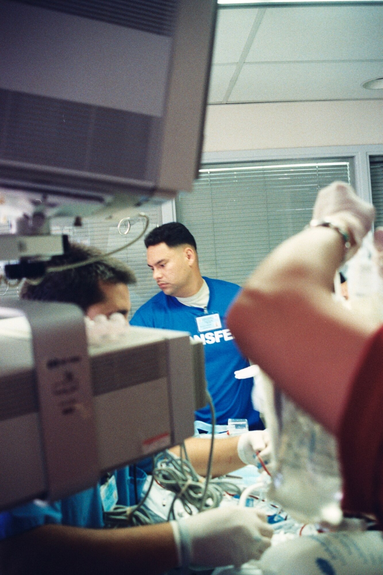 Chief Master Sgt. Kurt Koenig, 752 MDS, helps his transport team prepare to move a critical care patient from his hospital bed to a gurney. (Photo courtesy of Master Sgt. Raul Martir)