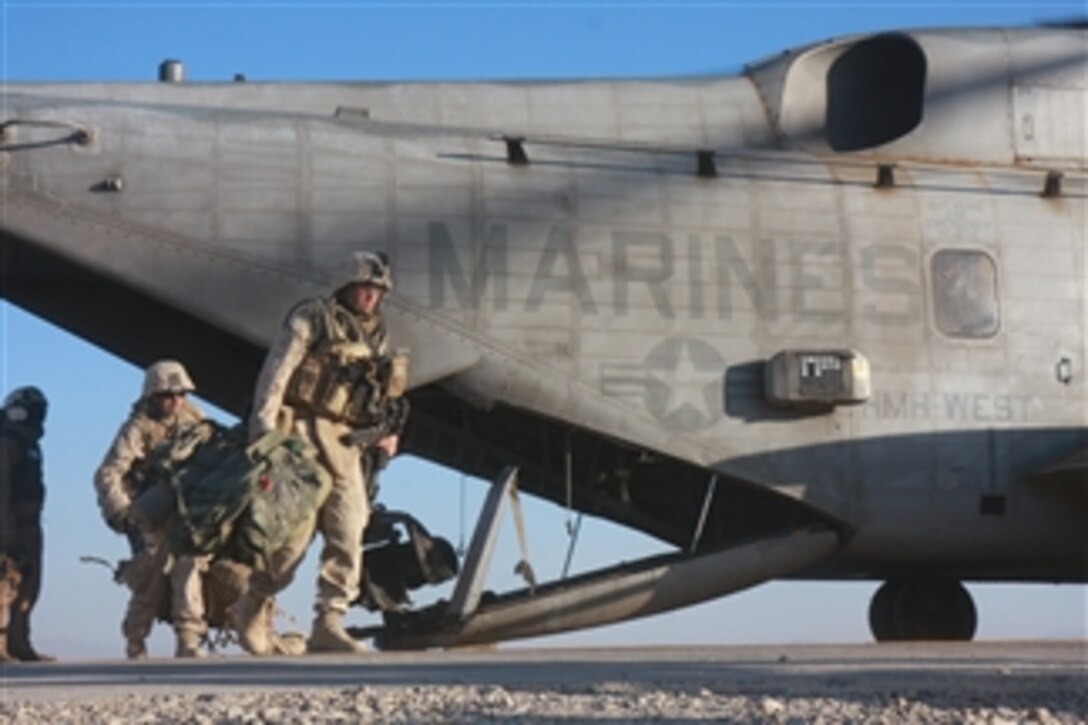 U.S. Marines of Foxtrot Company, 2nd Battalion, 7th Marine Regiment exit a CH-53 Super Stallion helicopter at Camp Bastion in Afghanistan after turning over their forward operating base to U.S. Marines of 3rd Battalion, 8th Marine Regiment on Nov. 17, 2008.  