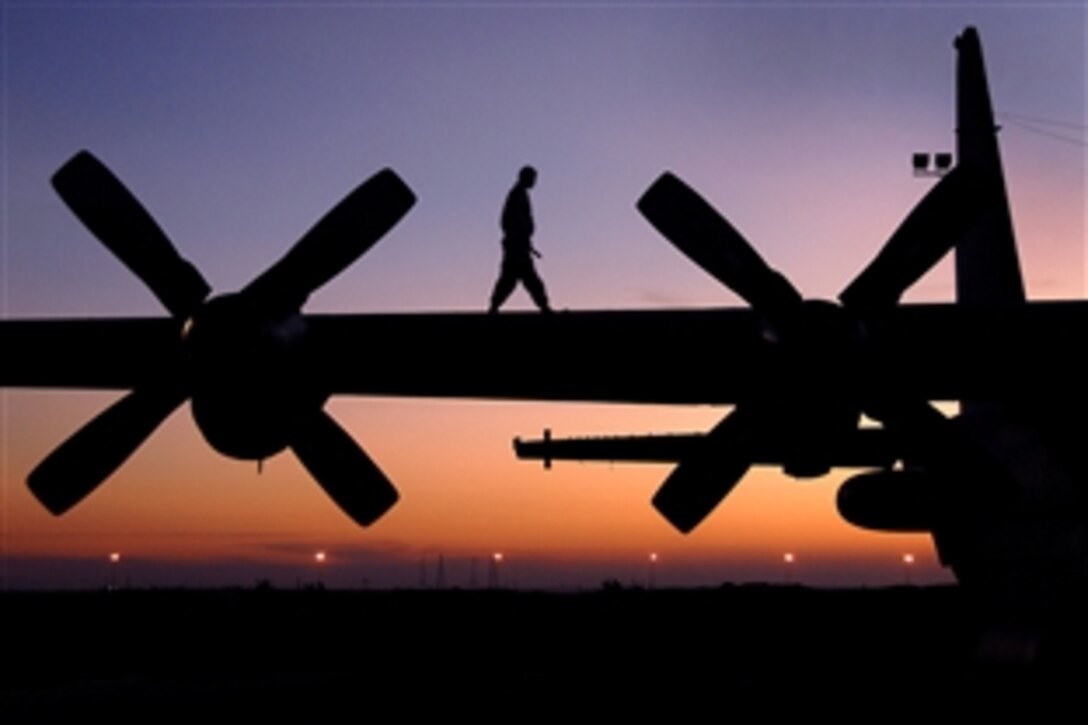 U.S. Air Force Sgt. Shane Kerns walks the wing of an EC-130 Compass Call aircraft while conducting a pre-flight check on an air base in Southwest Asia, Nov. 19, 2008. Kerns is assigned to the 386th Expeditionary Aircraft Maintenance Squadron.