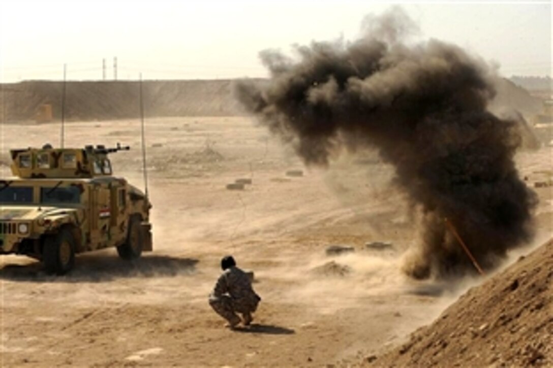 A  U.S. Army Special Forces soldier detonates an explosive during training with Iraqi soldiers on Camp Diwaniyah, Iraq, Nov. 11, 2008. A small explosive is used to simulate an improvised explosive device attack.