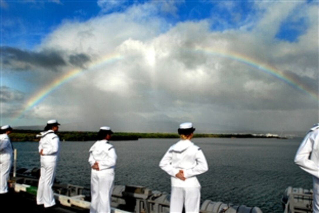 U.S. Navy sailors aboard the aircraft carrier USS Ronald Reagan man the rails as a rainbow forms across the skyline of Pearl Harbor, Hawaii, Nov. 17, 2008. Pearl Harbor is the final port visit of the deployment for Ronald Reagan.