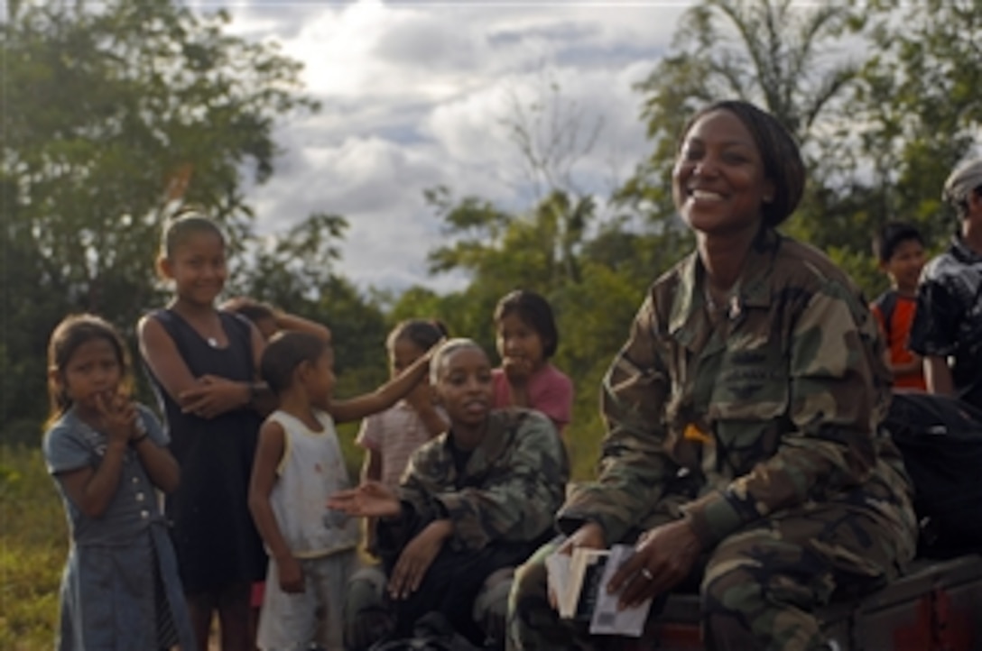 U.S. Navy Petty Officer 1st Class Ade Luna and Air Force Tech. Sgt. Carletta James, both embarked aboard the amphibious assault ship USS Kearsarge (LHD 3), speak to children during a medical assistance project in Santa Rosa, Guyana, on Nov. 15, 2008.  The Kearsarge is supporting the Caribbean phase of Continuing Promise 2008, an equal-partnership mission involving the United States, Canada, the Netherlands, Brazil, France, Nicaragua, Colombia, Dominican Republic, Trinidad and Tobago and Guyana.  