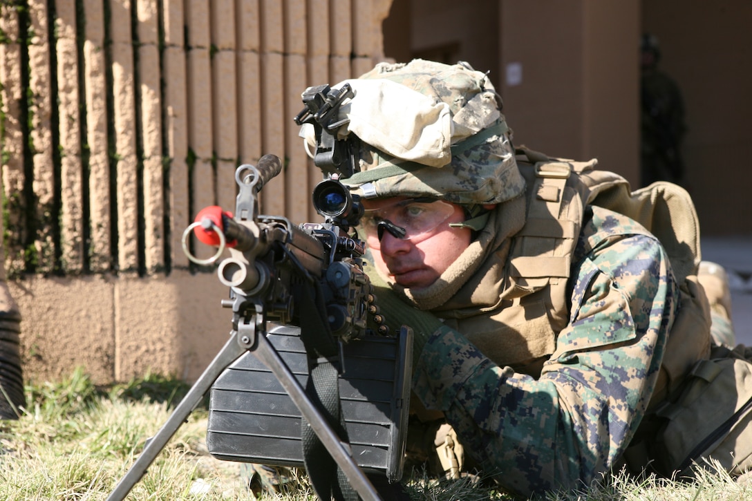 Lance Cpl. Mikal MacDonald, a squad automatic weapon gunner with Bravo Company, 1st Battalion, 8th Marine Regiment, 2nd Marine Division, posts security at a vehicle checkpoint at the military operations in urban terrain facility.  MOUT was used as part of a week-long battalion field exercise in preparation for the battalion’s deployment in support of Operation Iraqi Freedom.