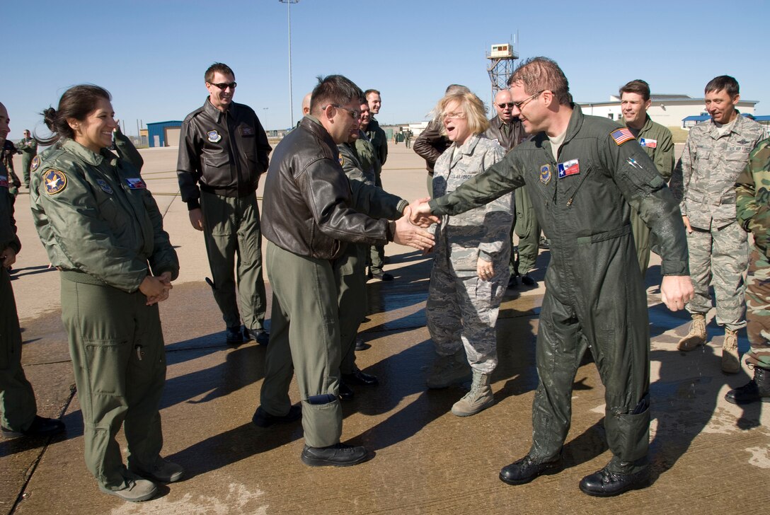 U.S. Air Force members from the 181st Airlift Squadron, Texas Air National Guard gather to congratulate Master Sgt. Ronald M Hughes as he completes his last mission as a flight engineer on the C-130 aircraft during the November Unit Training assembly, November 15,2008.(USAF Photo by Master Sgt. Michael Lachman)