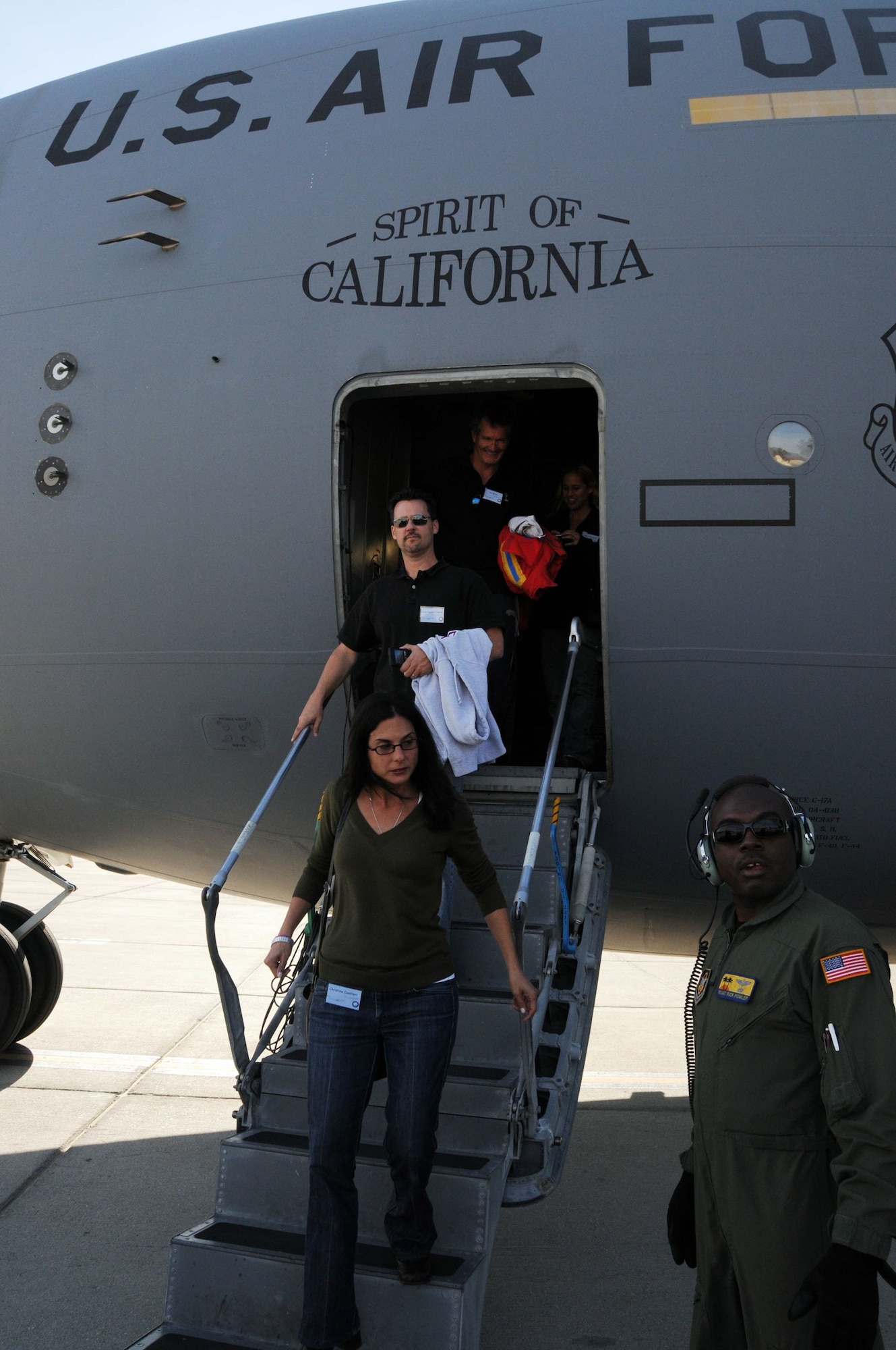 Members of the entertainment industry get familiar with a C-17 before their flight, and deplane after a refueling mission at March ARB as part of Air Force Week. (U.S. Air Force photo by Lt. Col. Francisco Hamm)