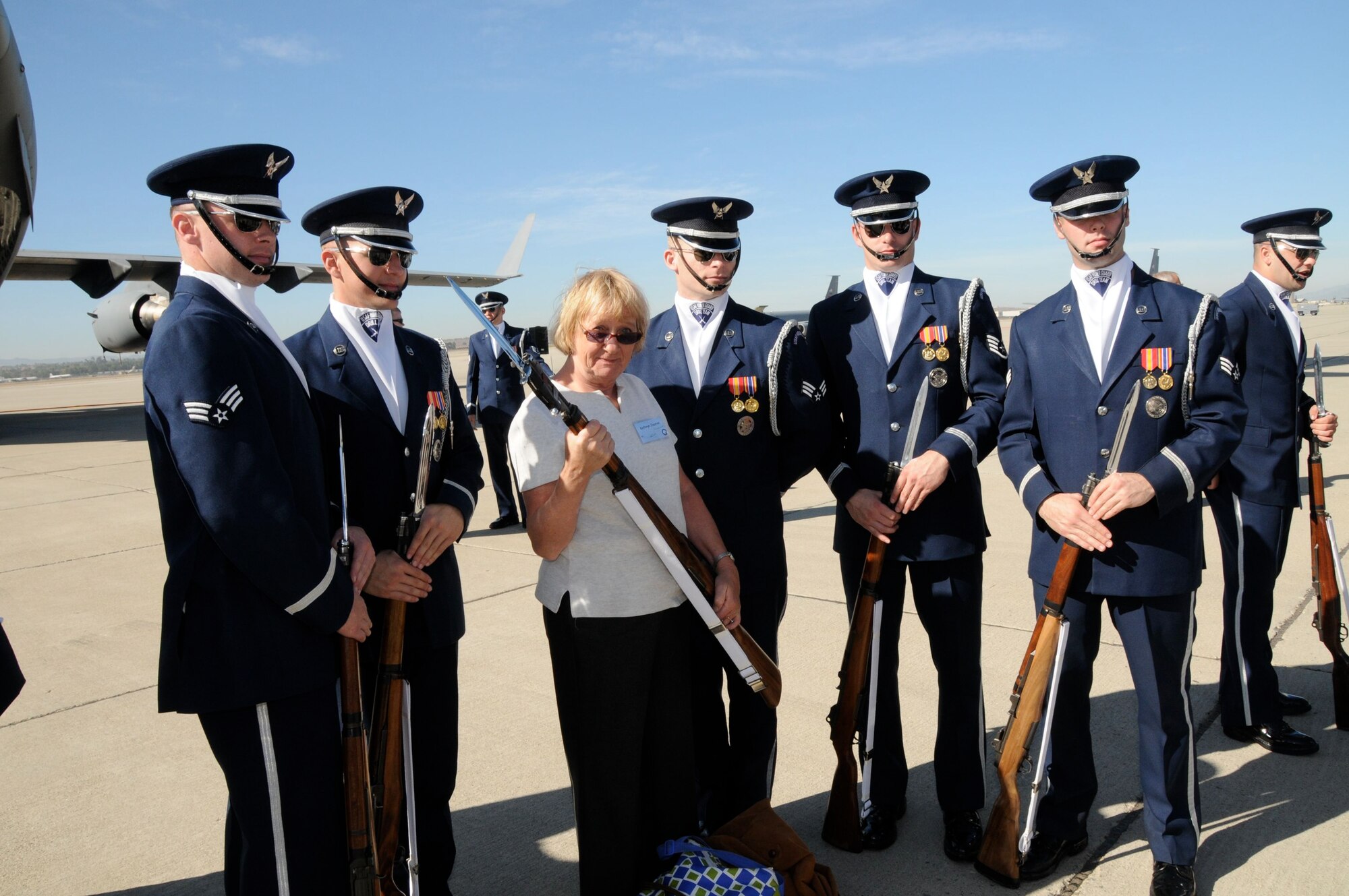One of the members of the entertainment industry takes a picture with members of the the U.S. Air Force Honor Guard Drill Team. The team performed for members of the media and entertainment industries as part of Air Force Week. (U.S. Air Force photo by Lt. Col. Francisco Hamm)