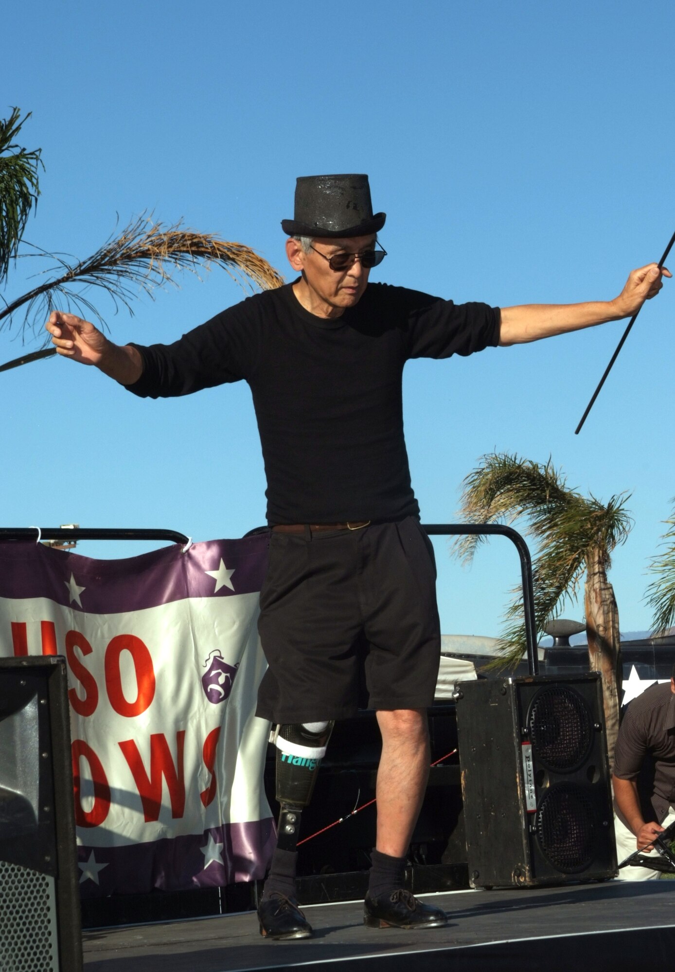 Sam Wang immigrated from China during the Second World War, with assistance from a general in the Army Air Corps. Having received care for tuberculosis (which cost him his leg) in American military hospitals, he now dedicates his time to support the troops by painting murals and tap dancing. Here, he performs during a dedication of the Bob Hope display at the March Air Field Museum on November 16. (U.S Air Force photo by Tech. Sgt. Joe Zucarro)