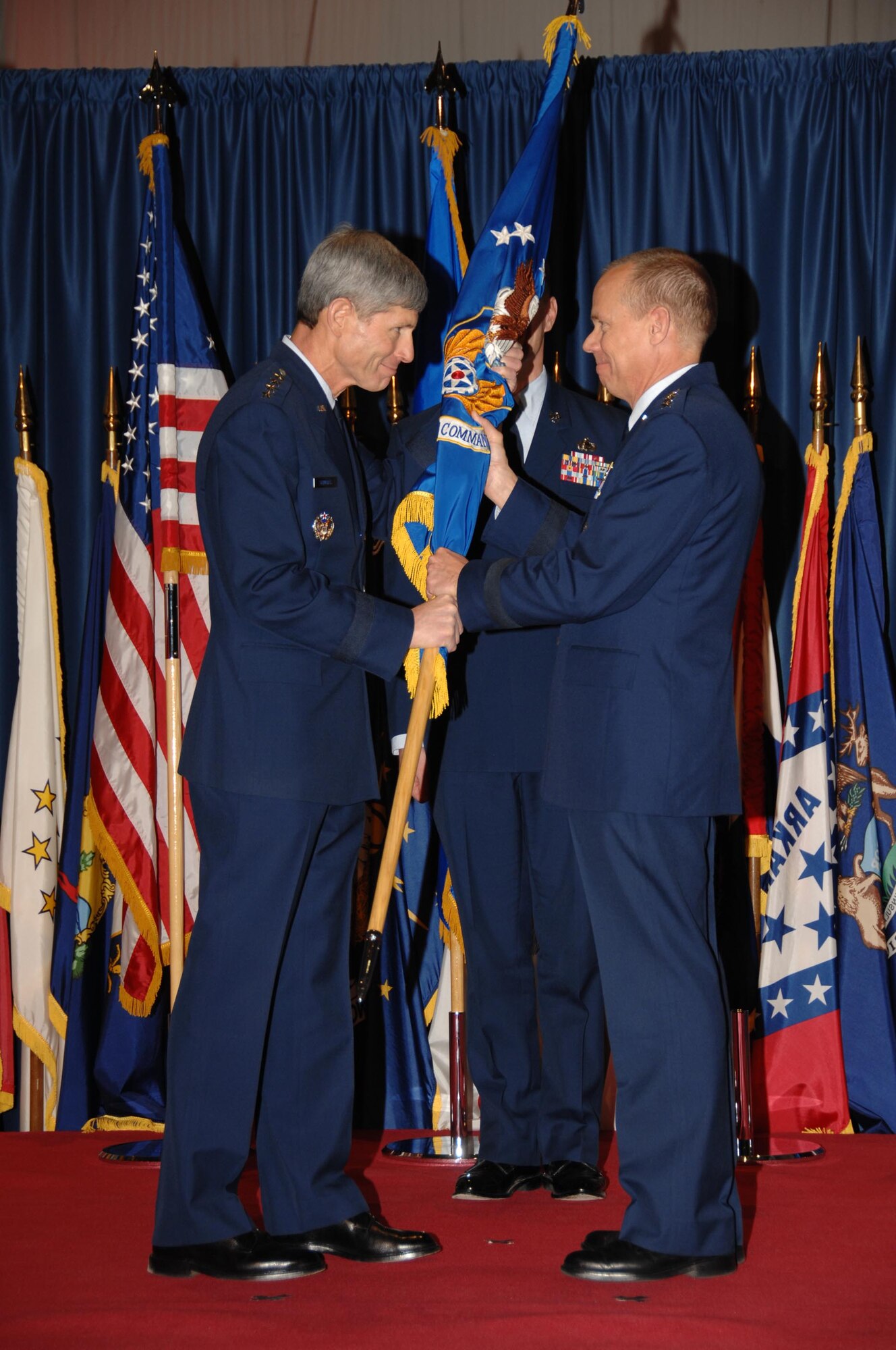 In the time-honored military tradition signifying assumption of command, Air Force Chief of Staff Gen. Norton Schwartz passes the Air Force Materiel Command guidon, or unit flag, to Gen. Donald Hoffman.  General Hoffman assumed command of AFMC Nov. 21 in a standing-room only ceremony at the National Museum of the U.S. Air Force at Wright-Patterson Air Force Base, Ohio, attended by a host of Air Force senior leaders.  (U.S. Air Force photo/Ben Strasser)