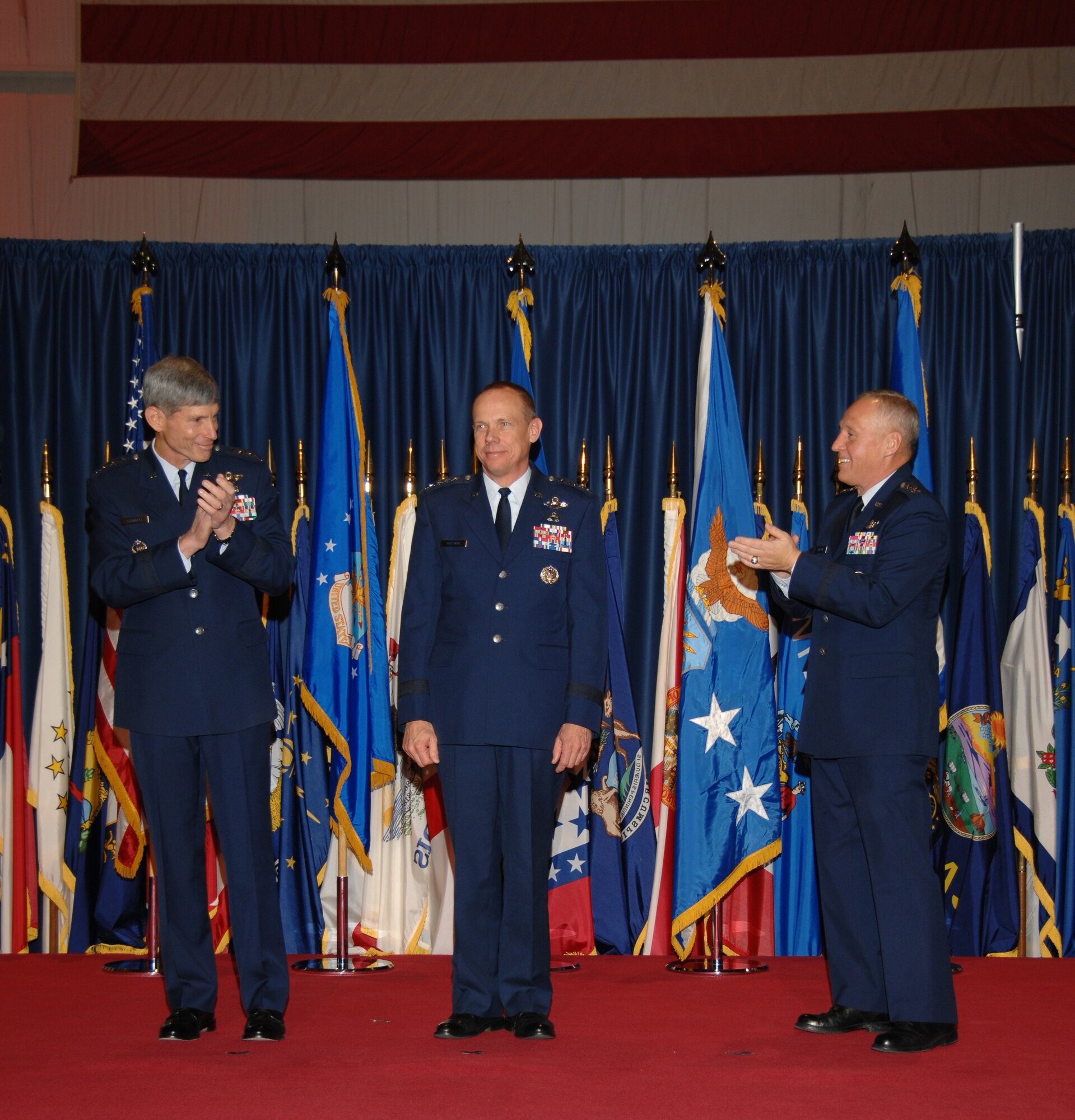 Air Force Chief of Staff Gen. Norton Schwartz (left) and Gen. Bruce Carlson (right) congratulate Gen. Donald Hoffman, who became the seventh commander of Air Force Materiel Command during a change-of-command ceremony Nov. 21. General Hoffman succeeds General Carlson, who is retiring almost 38 years of service. The event took place inside the National Museum of the United States Air Force at Wright-Patterson Air Force Base, Ohio. (U.S. Air Force photo/Ben Strasser) 