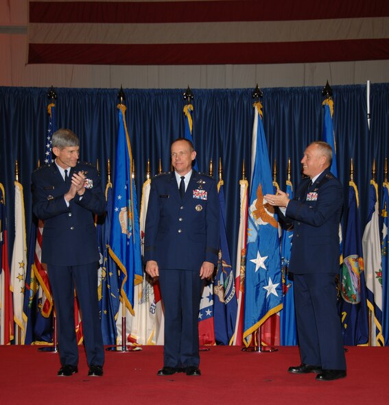 Air Force Chief of Staff Gen. Norton Schwartz (left) and Gen. Bruce Carlson (right) congratulate Gen. Donald Hoffman, who became the seventh commander of Air Force Materiel Command during a change-of-command ceremony Nov. 21. General Hoffman succeeds General Carlson, who is retiring almost 38 years of service. The event took place inside the National Museum of the United States Air Force at Wright-Patterson Air Force Base, Ohio. (Air Force photo by Ben Strasser) 