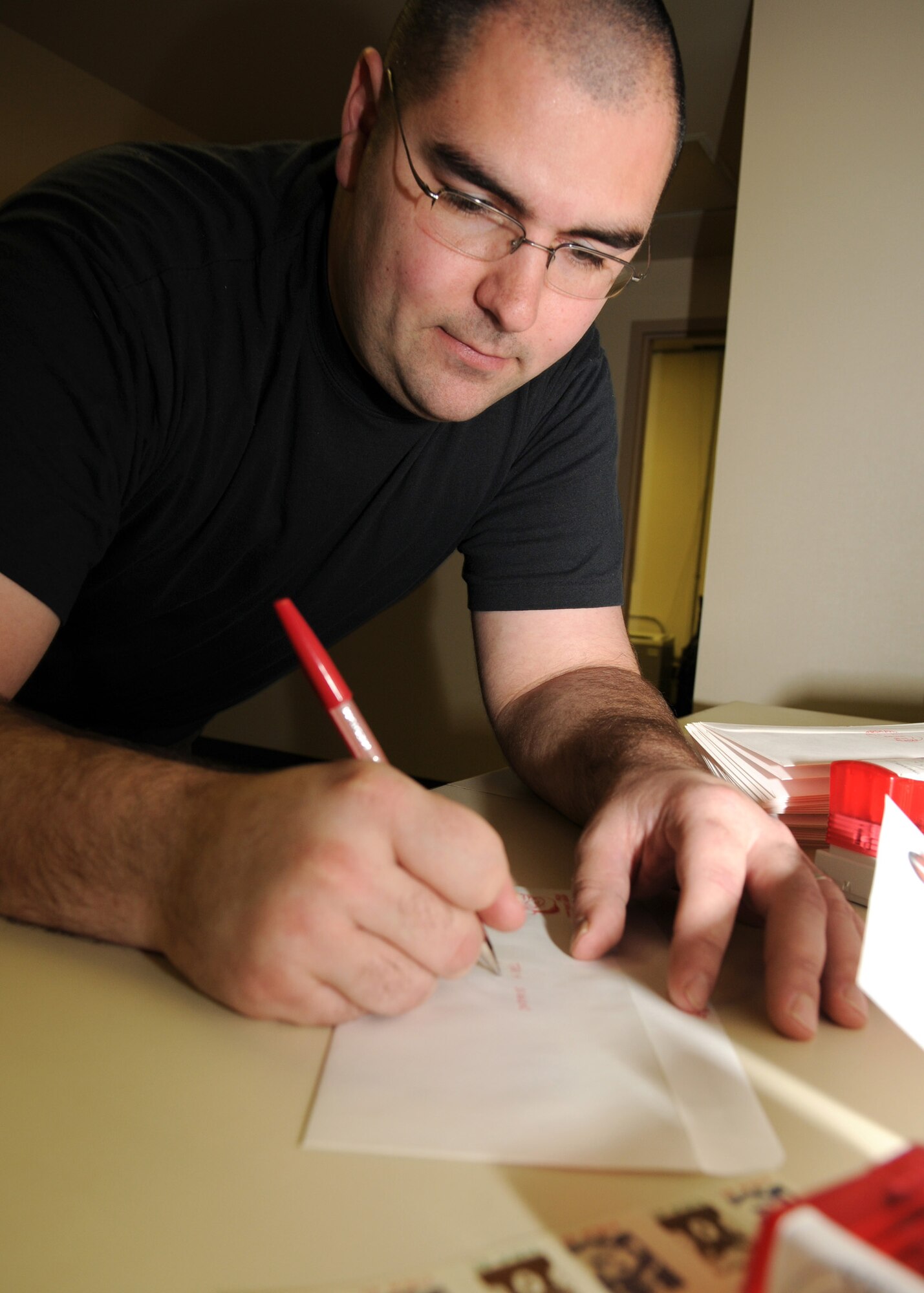 Staff Sgt. Matthew Bohlman, 354th Operations Support Squadron weather technician, responds to a child's letter addressed from Santa Claus as a part of the Santa's Mailbag program, Nov 21, 2008, Eielson AFB, Alaska.  The 354th OSS's Santa's Mailbag program reads and responds to letters written from children all over the world. This program has been active for 54 years and is a holiday tradition for the men and women of the 354th Operation Support Squadron weather flight.  To send letters to Santa, send a self-addressed, stamped envelope to:  SANTA'S MAILBAG, 354th OSS/OSW, 2827 Flightline Ave., Suite 100B, Eielson AFB, Alaska 99702.   (U.S Air Force photo/Staff Sgt. Tia Schroeder)