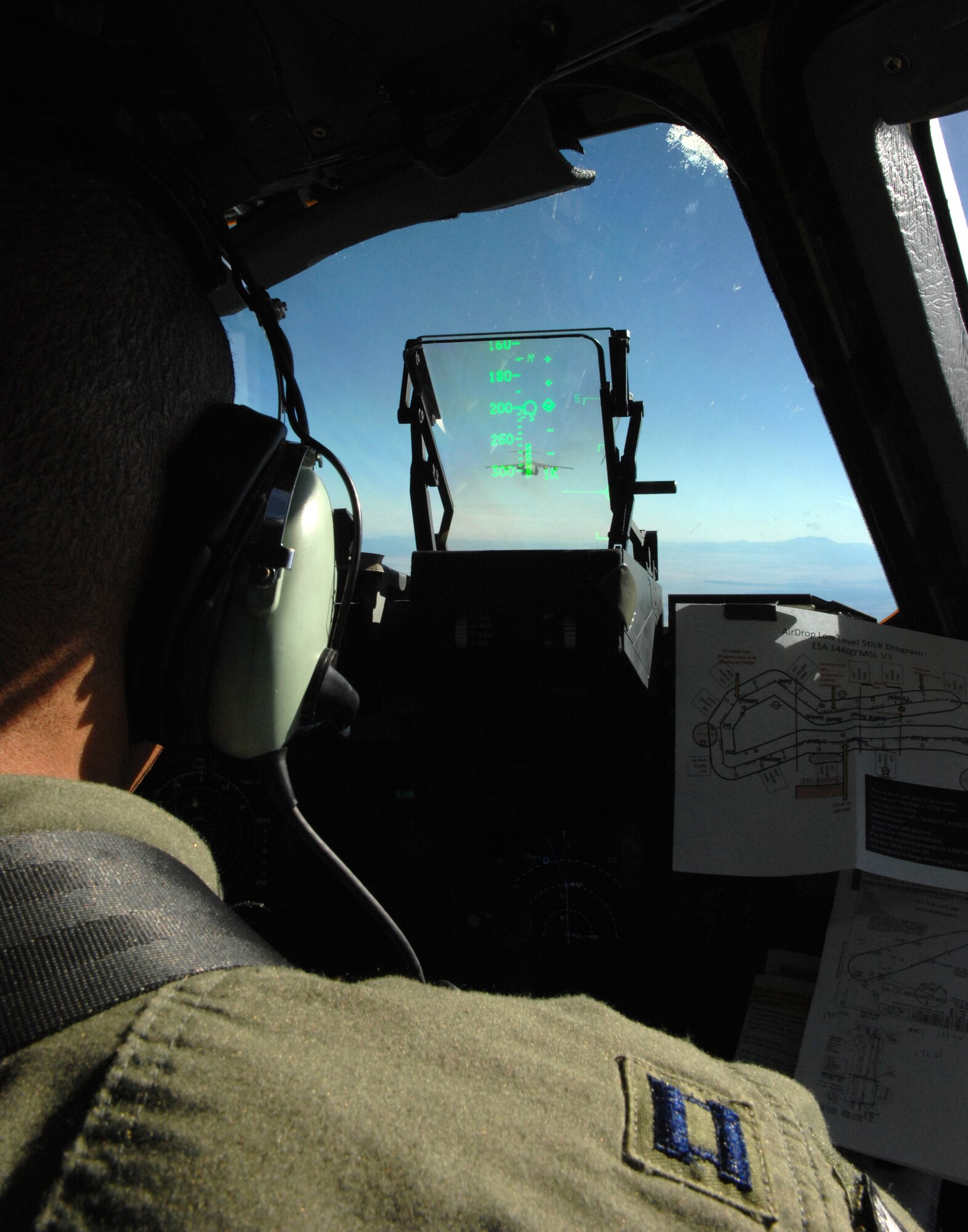 Capt. Bryan Granger, a C-17 Globemaster pilot assigned to the 58th Airlift Squadron, Altus Air Force Base, Okla., eyes the lead C-17 in formation during the U.S. Air Force Weapons School's Mobility Air Forces Exercise, MAFEX, at Nellis Air Force Base, Nev., Nov. 19, 2008. Approximately twelve U.S. Air Force bases participate in MAFEX at the U.S. Air Force Weapons School twice a year, testing C-17 Globemasters and C-130 Hercules crews' ability to join together in a formation at a specific time and location to drop a brigade sized force anywhere in the world. (U.S. Air Force Photo/Senior Airman Larry E. Reid Jr., Released)