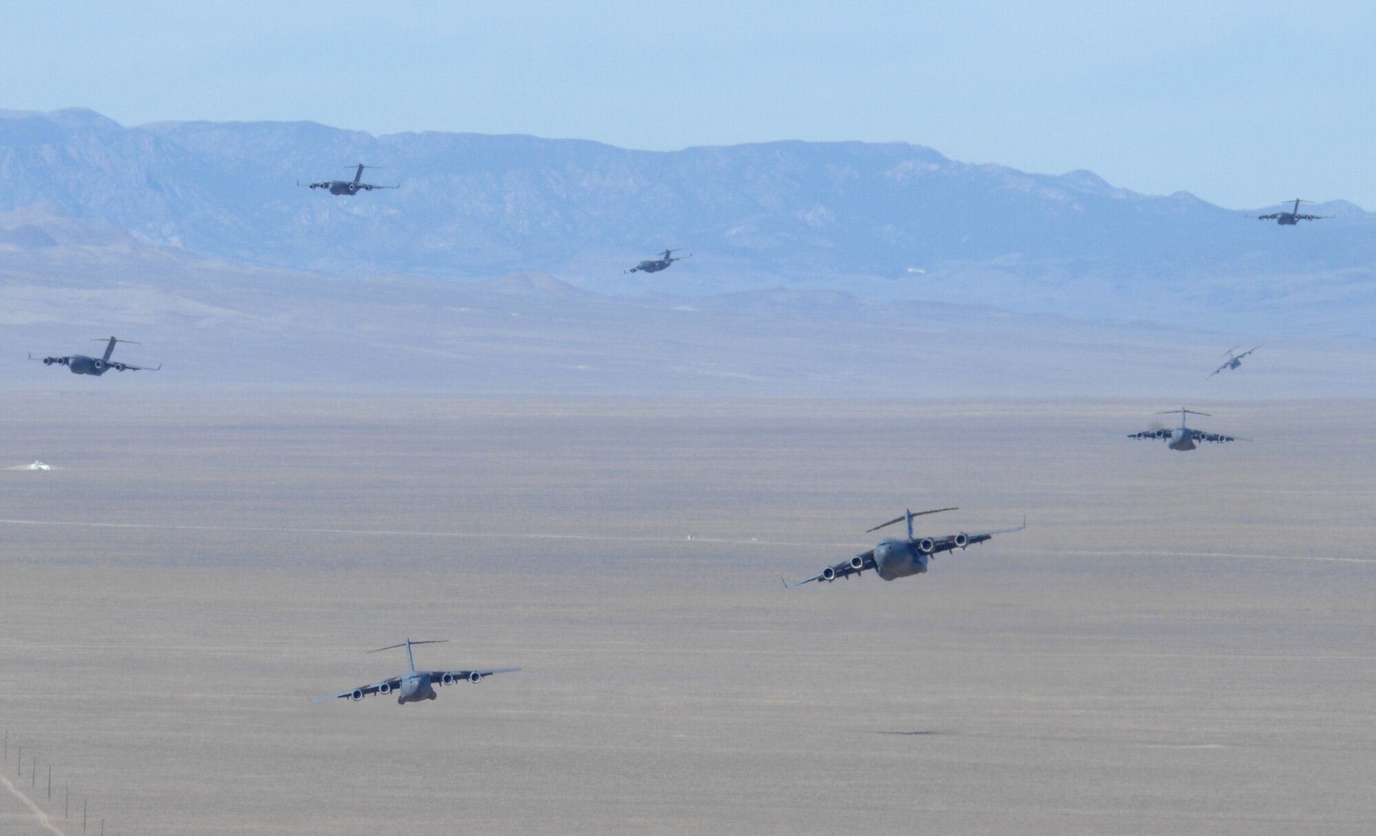 A formation of C-17 Globemasters soar over the Nevada desert during the U.S. Air Force Weapons School's Mobility Air Forces Exercise, MAFEX, at Nellis Air Force Base, Nev., Nov. 19, 2008. Approximately twelve U.S. Air Force bases participate in MAFEX at the U.S. Air Force Weapons School twice a year, testing C-17 Globemasters and C-130 Hercules crews' ability to join together in a formation at a specific time and location to drop a brigade sized force anywhere in the world. (U.S. Air Force Photo/Senior Airman Larry E. Reid Jr., Released)