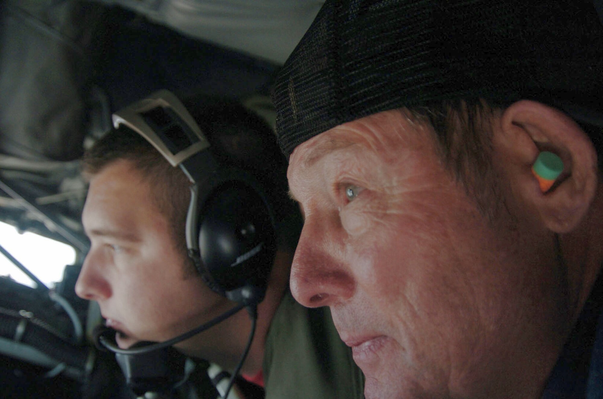 Ronnie McLean of Altus, Okla., observes the refueling of a C-17 Globemaster III from the boom pod of a KC-135 Stratotanker as the boom operator, Staff Sgt. Bruce Bergland, conducts the refueling procedure.  Neighbors of Altus Air Force Base, Okla., visited the base Nov. 14 as part of the Farm-City community outreach program.  Some of the guests experienced the air refueling mission from the tanker and others from the receiver, the C-17.  (U.S. Air Force photo/Master Sgt. Paul Dean) 