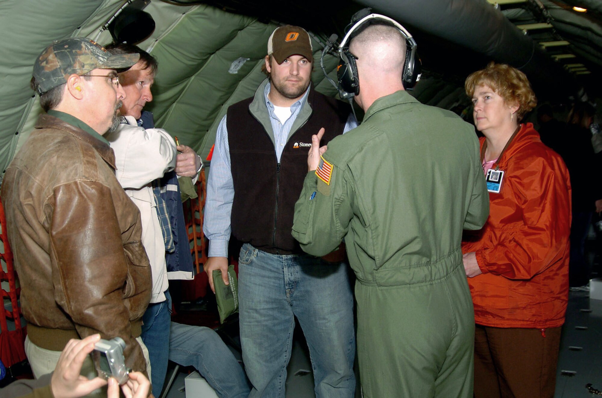 Staff Sgt. Doug Boren, a KC-135 Stratotanker boom operator, answers questions about the Air Force and the aircraft during an orientation flight for neighbors of Altus Air Force Base, Okla., Nov. 14 as part of the Farm-City community outreach program.  While some of the guests experienced the air refueling mission from the tanker, others saw the refueling from the receiver, a C-17 Globemaster III.  (U.S. Air Force photo/ Master Sgt. Paul Dean) 