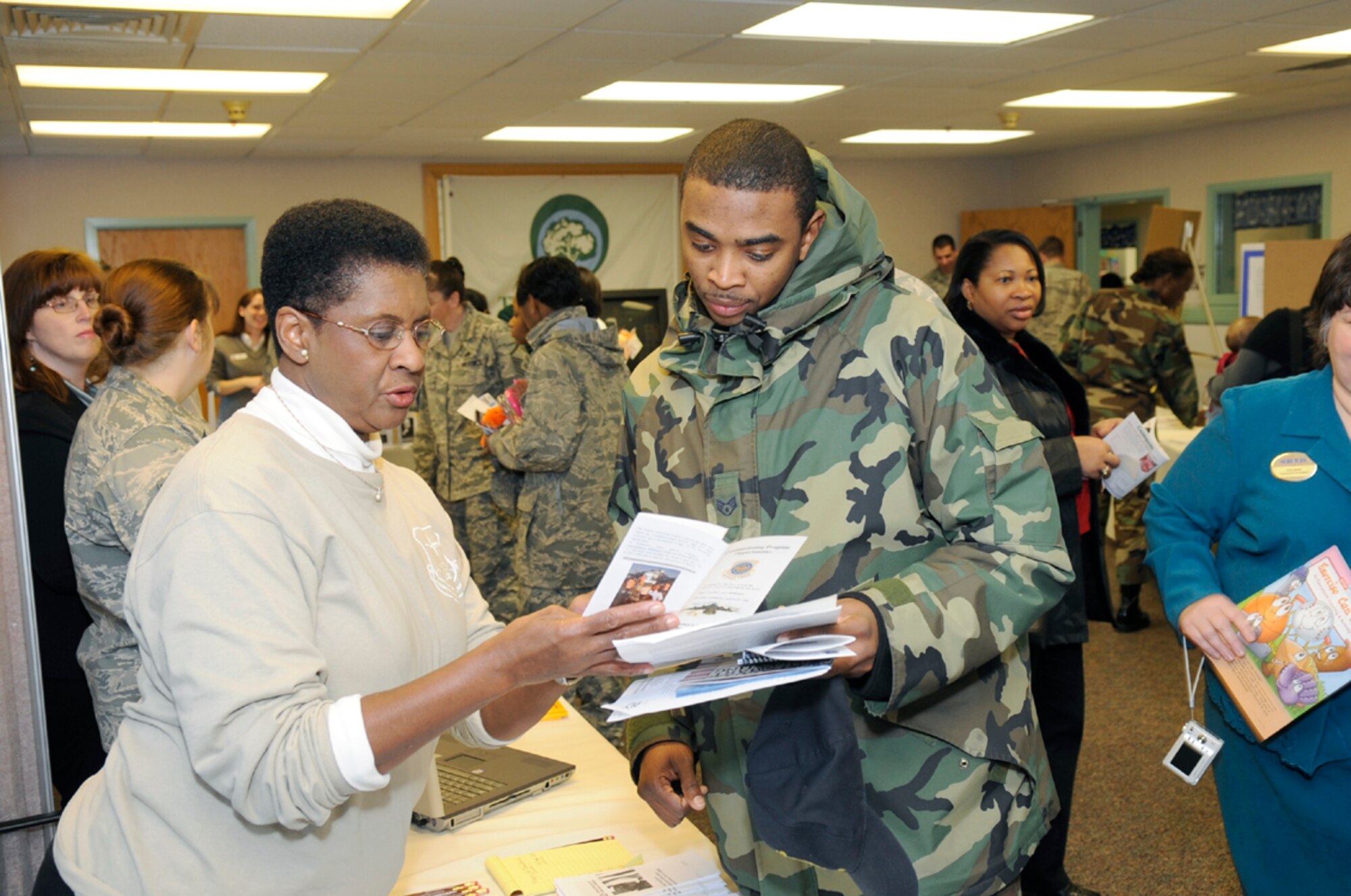 Gaylor Simons, 305th Mission Support Squadron Education office, provides information to an Airman during the Community Resource Fair at Child Development Center 1 Nov. 21. The fair was held during Wingman Day, which focuses on Airmen taking care of each other. (U.S. Air Force photo/Carlos Cintron) 