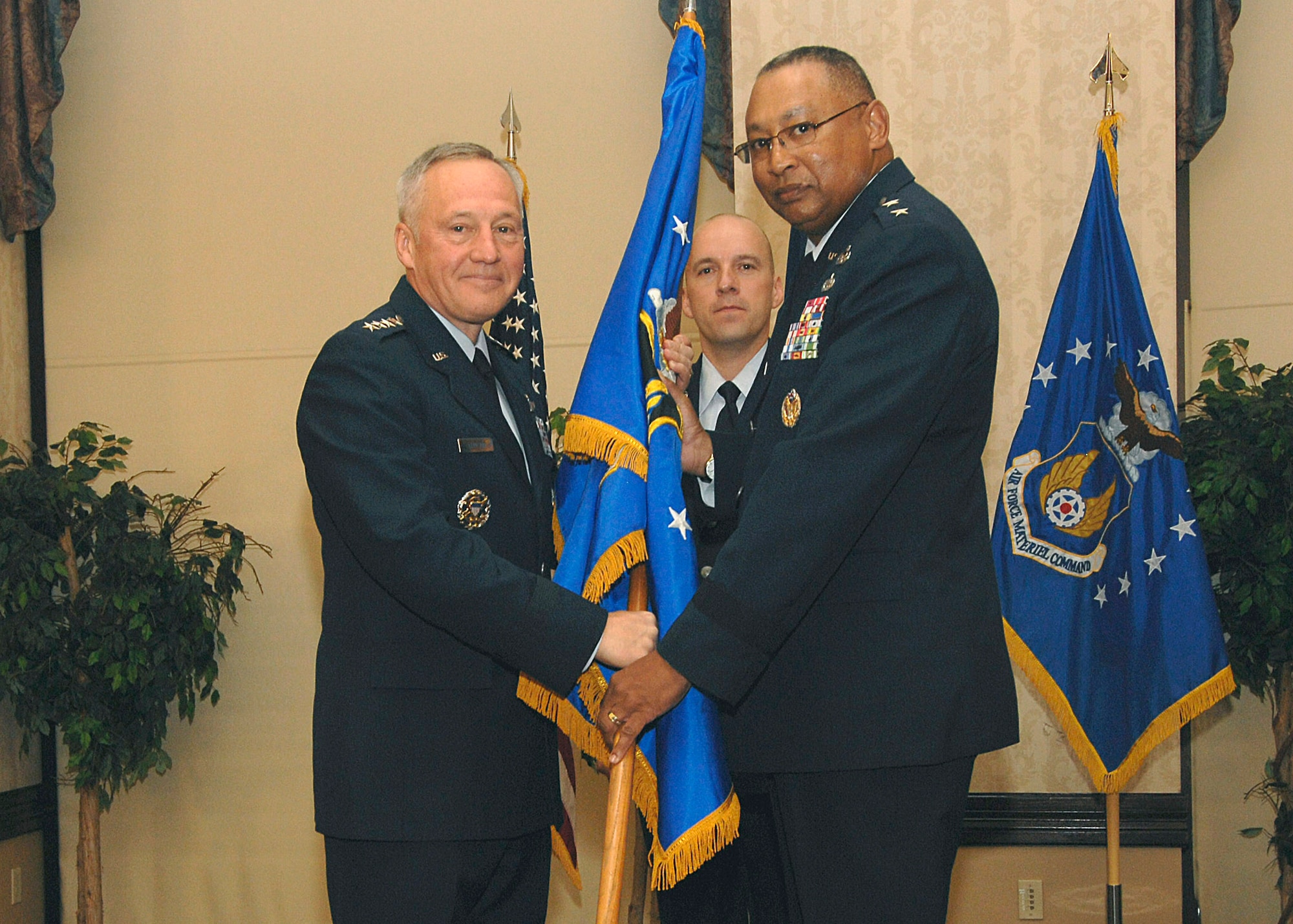 SCOTT AIR FORCE BASE, Ill. -- Gen. Bruce Carlson, Air Force Materiel Command commander, passes command of the Air Force Global Logistics Support Center forward to Maj. Gen. Gary T. McCoy during a change of command ceremony at the Scott Club Nov. 13. 

(U.S. Air Force photo/Tech. Sgt. Michelle Larche)