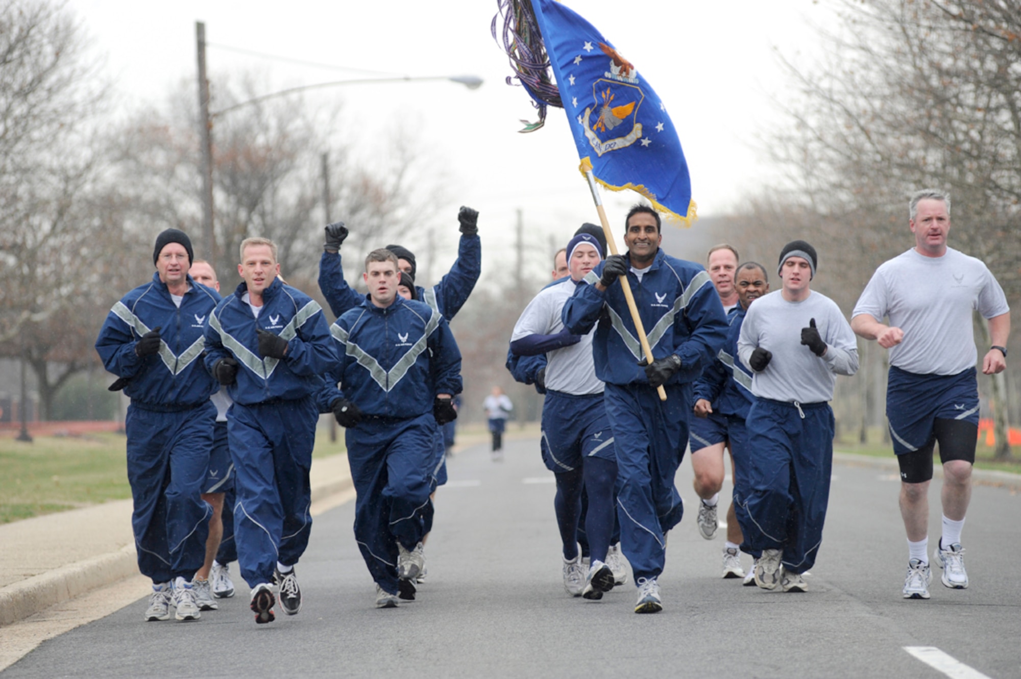 The 305th Air Mobility Wing staff, lead by Col. Balan Ayyar, 305th Air Mobility Wing commander (center), charge toward the finish line during the annual Wingman Day Warrior Run Nov. 21. Wingman Day focuses on building relationships between Airmen through friendly sports and professional education. (U.S. Air Force photo/Carlos Cintron)