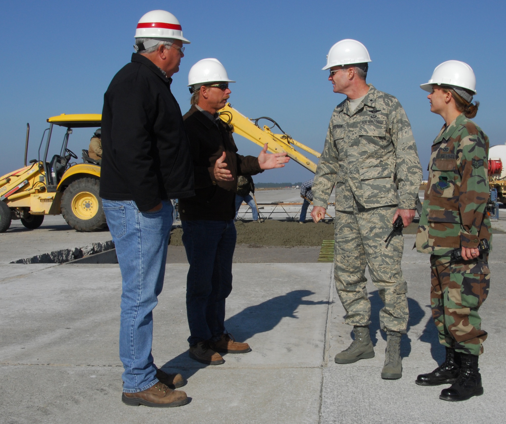 Senior Airman Shannon Hawkins, 325th Operations Support Squadron Airfield Management Operations shift leader, and Brig. Gen. Darryl Roberson, 325th Fighter Wing commander, discuss with John Adams and Marlon Kirtland from the 325th Civil Engineer Squadron about the status of the runway repairs.  Airman Hawkins, selected for the Commander’s Shadow Program, is responsible for maintaining situational awareness of airfield activities and has overall responsibility for Airfield Management Operations sections.   “She is a true go-getter who is always looking for ways to improve the mission,” said Tech. Sgt. Edward Tyre, Airman Hawkins’ supervisor and nominator.  Serving in the Air Force for almost three years, Airman Hawkins hails from Huntsville, Ala.  (U.S. Air Force photo by Lisa Norman)