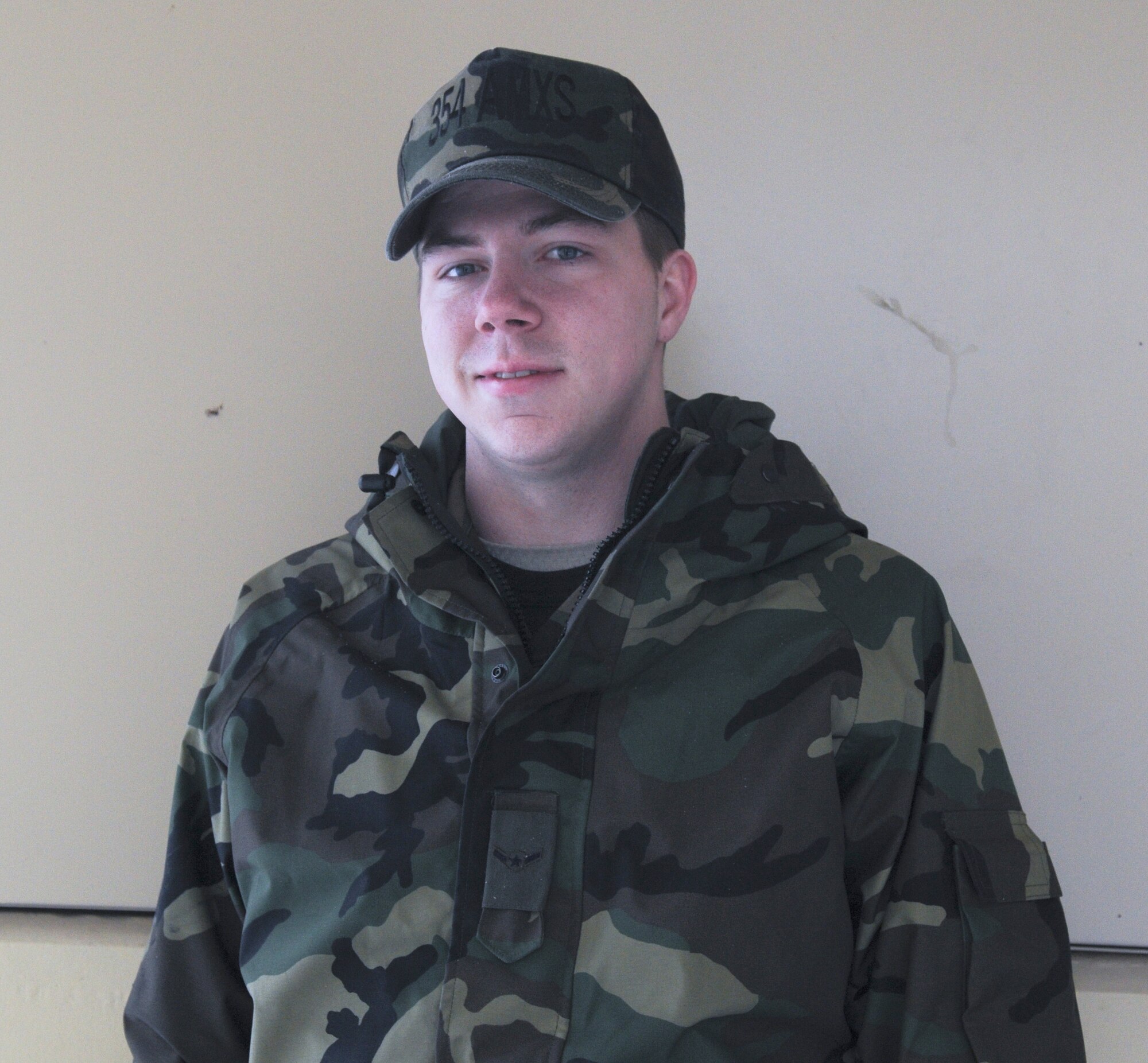 Airman James Miles, 354th Aircraft maintenance Squadron, enjoys a large family meal. He also plays football with his brothers and watches the game.  Airman Miles roots for the Dallas Cowboys. (U.S. Air Force photo/ Airman Laura Max)