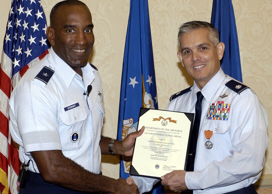 Brig. Gen. A.J. Stewart, Air Force Recruiting Service commander, presents Lt. Col. Javier Casanova the Combat Action Medal Thursday at the AFRS Leadership conference in San Antonio, Texas. Colonel Casanova, who was also awarded an Air Medal, came under intense enemy fired during a combat search and rescue operation when retrieving wounded people in Fallusia, Iraq. The Combat Action Medal is awarded to Airmen who have been involved in direct fighting situations where they risked their lives in an enemy engagement. Colonel Casanova is the 349th Recruiting Squadron commander, headquartered at Tinker Air Force Base, Okla. (U.S. Air Force photo/Ronn Linn)