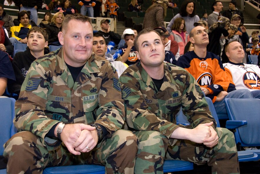 Tech Sgt. Christian M. Cote and Staff Sgt. Ellis J. Couch, 106th Security Forces Squadron, enjoy the hockey game. 

The 106th Rescue Wing's Pararescue Jumpers (PJs) helped make Veteran's Day memorable for those in attendance at the New York Islander hockey game on November 11 at Nassau Veterans Memorial Coliseum, Uniondale, N.Y. The PJs rappelled off the rafters of the coliseum carrying the United States flag while the National Anthem was being played by the Air Force Liberty Brass Band. Former U.S. Secretary of State Colin Powell made an appearance and helped out by dropping the ceremonial first puck along with Islander's owner Charles Wang. 
(U.S. AF Photo/Staff Sgt. Marcus A. Calliste)
