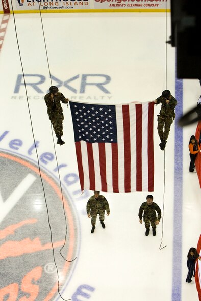 The 106th Rescue Wing's Pararescue Jumpers (PJs) helped make Veteran's Day memorable for those in attendance at the New York Islander hockey game on November 11 at Nassau Veterans Memorial Coliseum, Uniondale, N.Y. The PJs rappelled off the rafters of the coliseum carrying the United States flag while the National Anthem was being played by the Air Force Liberty Brass Band. Former U.S. Secretary of State Colin Powell made an appearance and helped out by dropping the ceremonial first puck along with Islander's owner Charles Wang. 
(U.S. AF Photo/Staff Sgt. Jordan A. Miles)