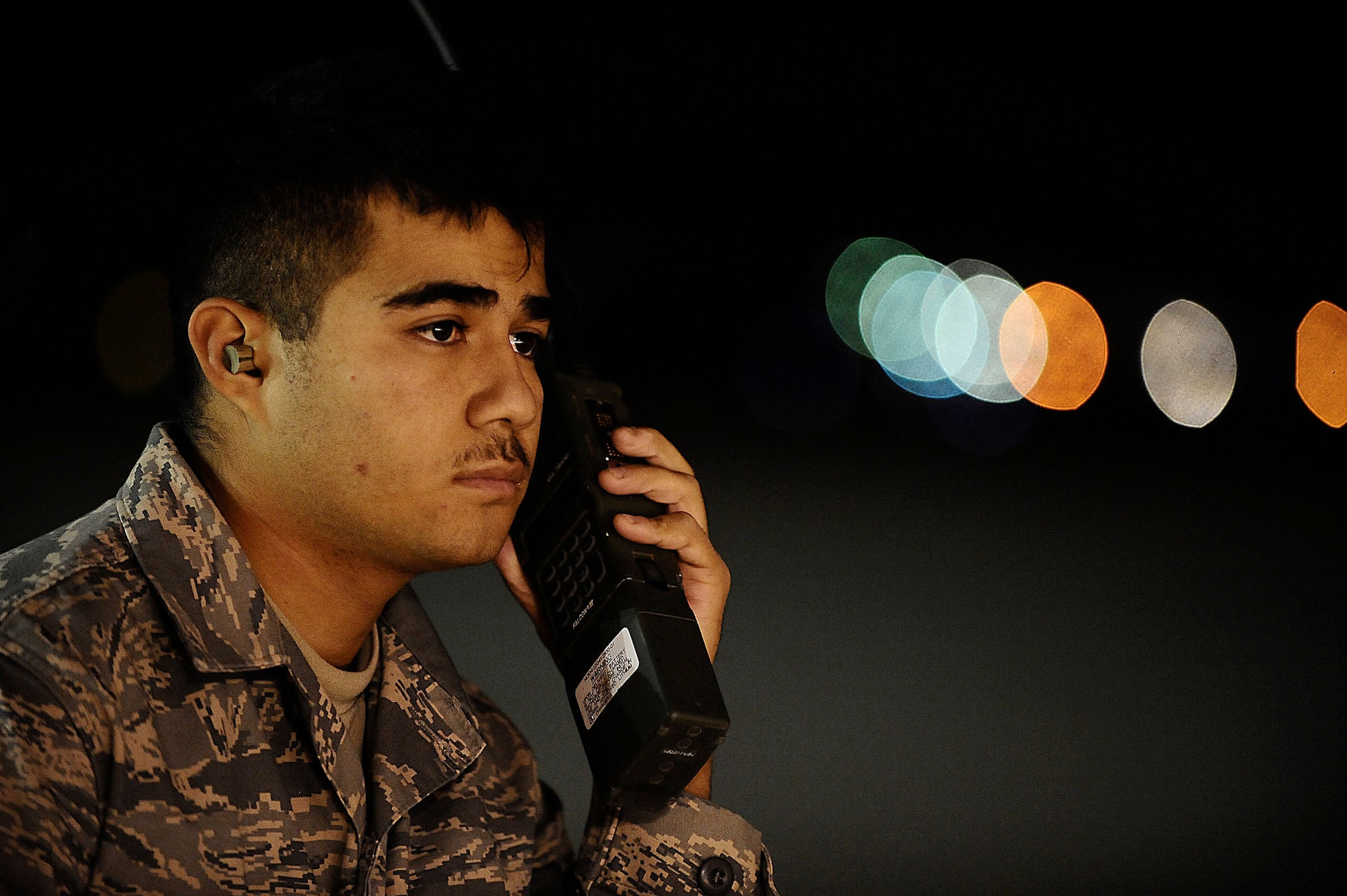 Airman 1st Class Hugo Garnica communicates with an MQ-9 Reaper pilot using a land mobile radio at Joint Base Balad, Iraq, Nov. 18. He was performing a preflight check to ensure the unmanned aircraft vehicle was operational. Airman Garnica, an assistant dedicated crew chief assigned to the 332nd Expeditionary Aircraft Maintenance Squadron, is deployed from Creech Air Force Base, Nev. (U.S. Air Force photo/Airman 1st Class Jason Epley)