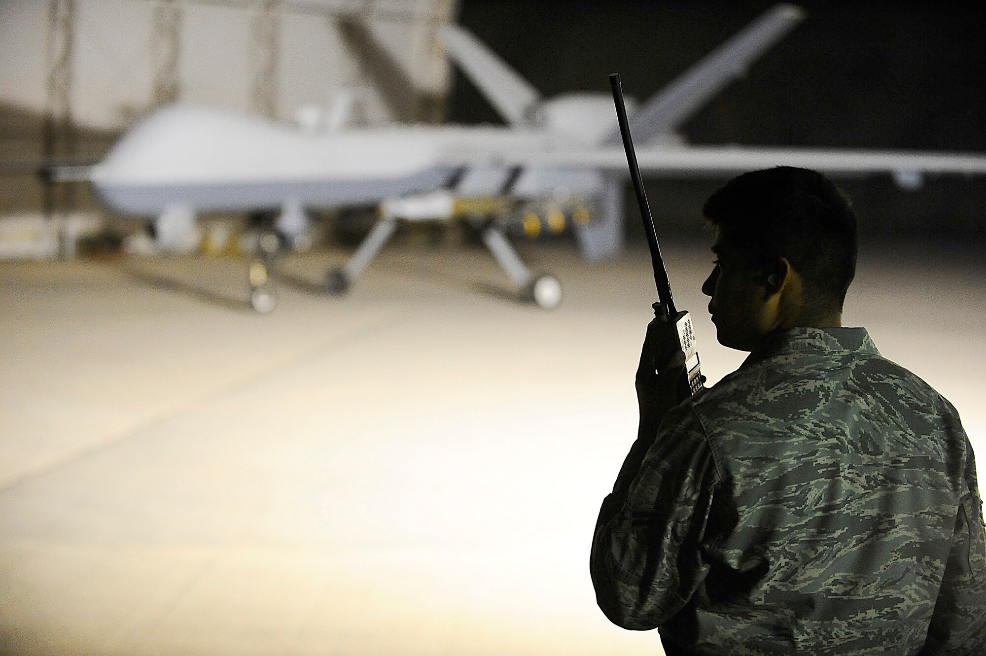 Airman 1st Class Hugo Garnica communicates with an MQ-9 Reaper pilot with a land mobile radio at Joint Base Balad, Iraq, Nov. 18. He was performing a preflight check to ensure the unmanned aircraft vehicle was operational. Airman Garnica, an assistant dedicated crew chief assigned to the 332nd Expeditionary Aircraft Maintenance Squadron, is deployed from Creech Air Force Base, Nev. (U.S. Air Force photo/Airman 1st Class Jason Epley)