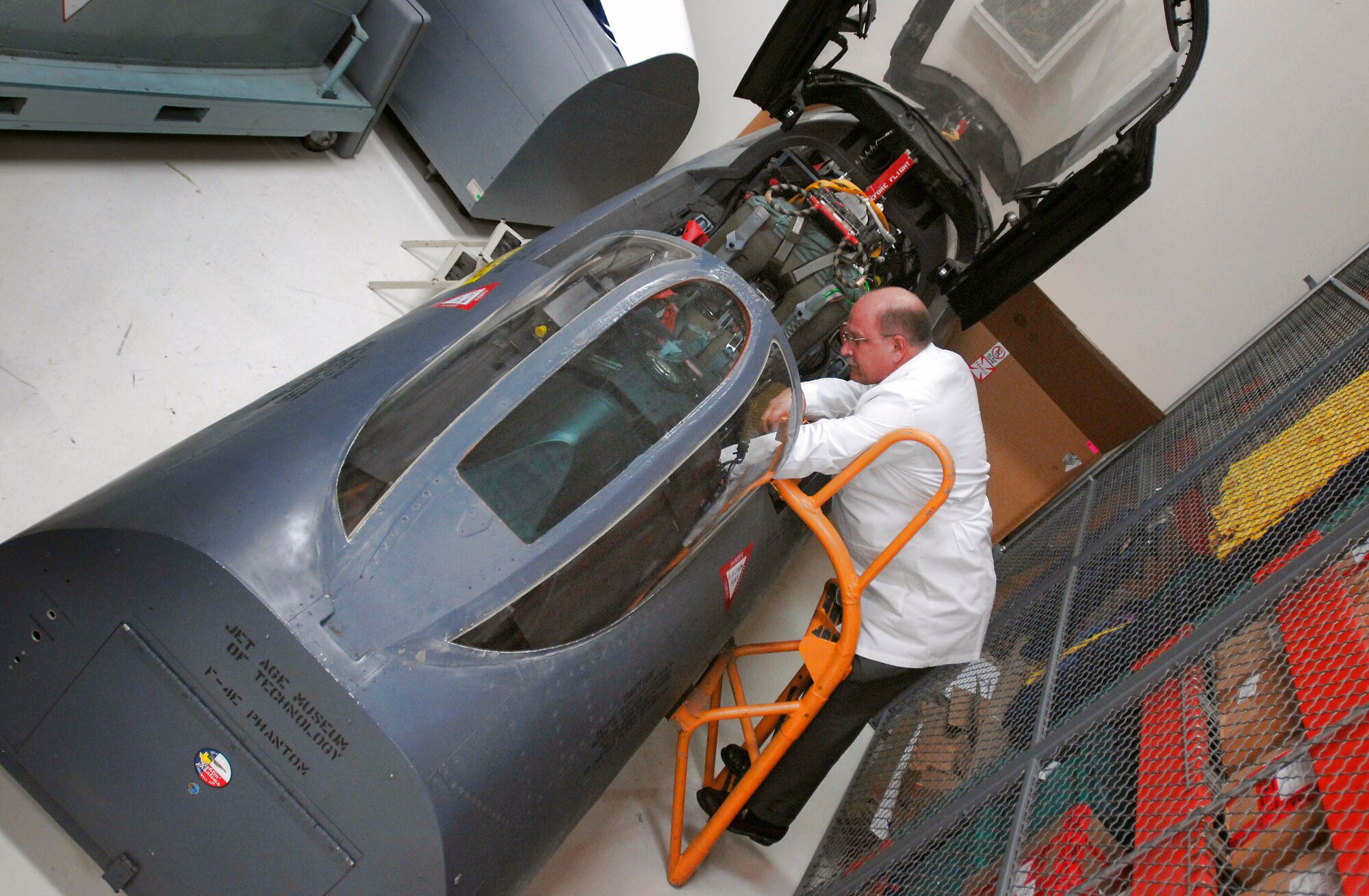 Robert Browning III looks into the cockpit of an F-4 Phantom II fighter jet Nov. 4 at Brooks City-Base, Texas. The lab has rebuilt cockpits of a dozen Vietnam War-era aircraft it uses to help make identifications of missing servicemembers. Mr. Browning is an equipment analyst at the Life Sciences Equipment Laboratory. (Department of Defense photo/Fred Baker III) 
