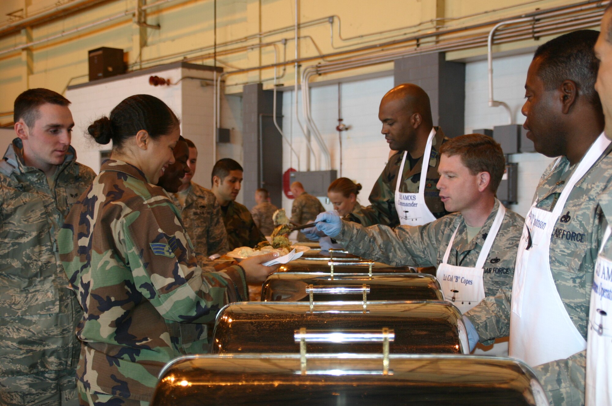 Lt. Col. Robert Copes, commander, 552nd Maintenance Squadron, serves a heaping scoop of stuffing to one of the deserving Airmen at the MXG Turkey Feast November 20. Photo compliments of 1st Lt. Kinder Blacke.